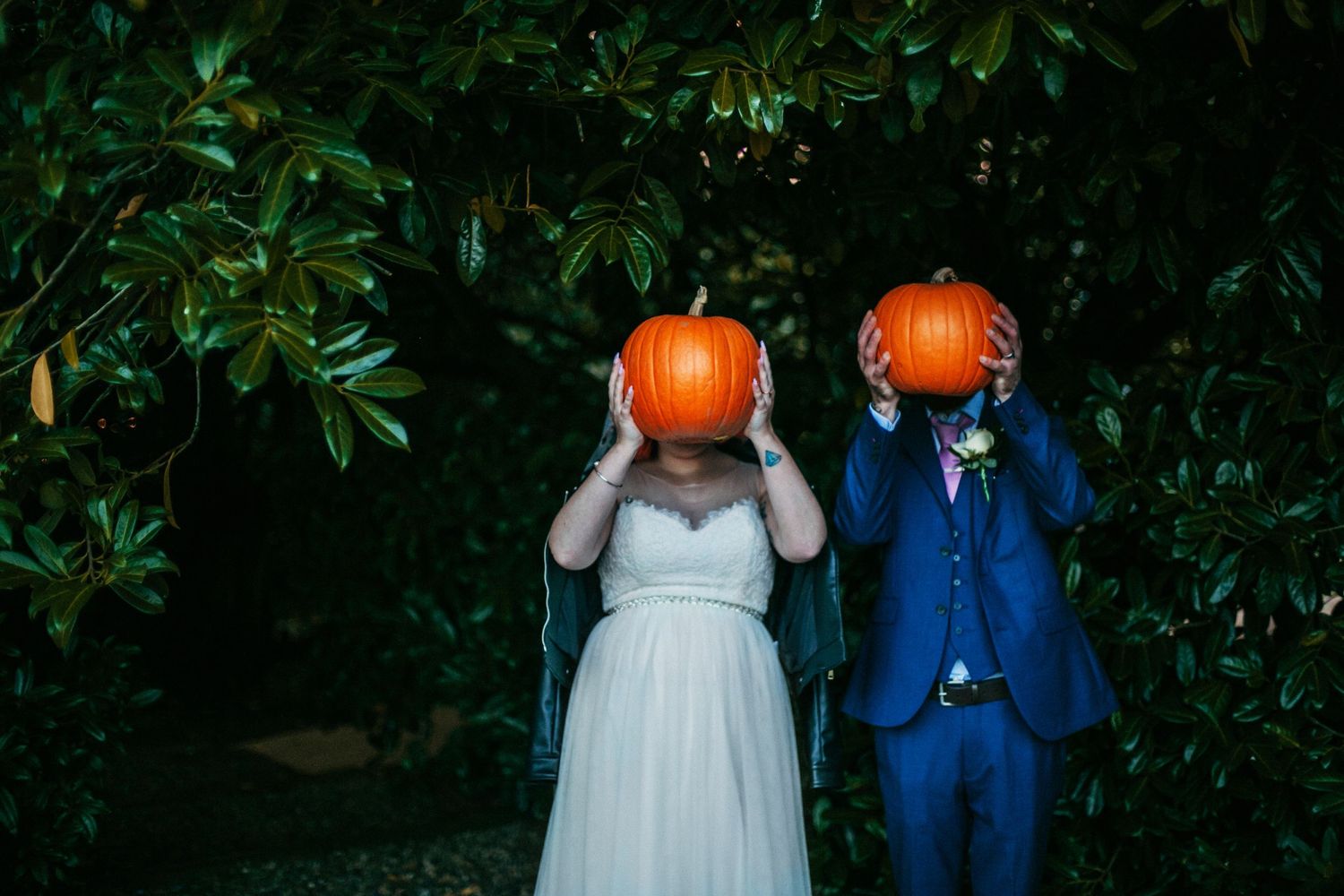 Love and Fun - The couple place pumpkins in front of their faces creating pumpkin heads