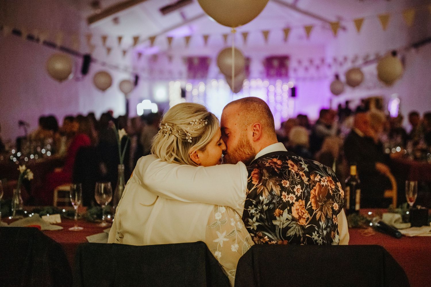 Bride and groom kissing at their wedding reception at Cottered Village Hall Hertfordshire, Photographer RELM Photography