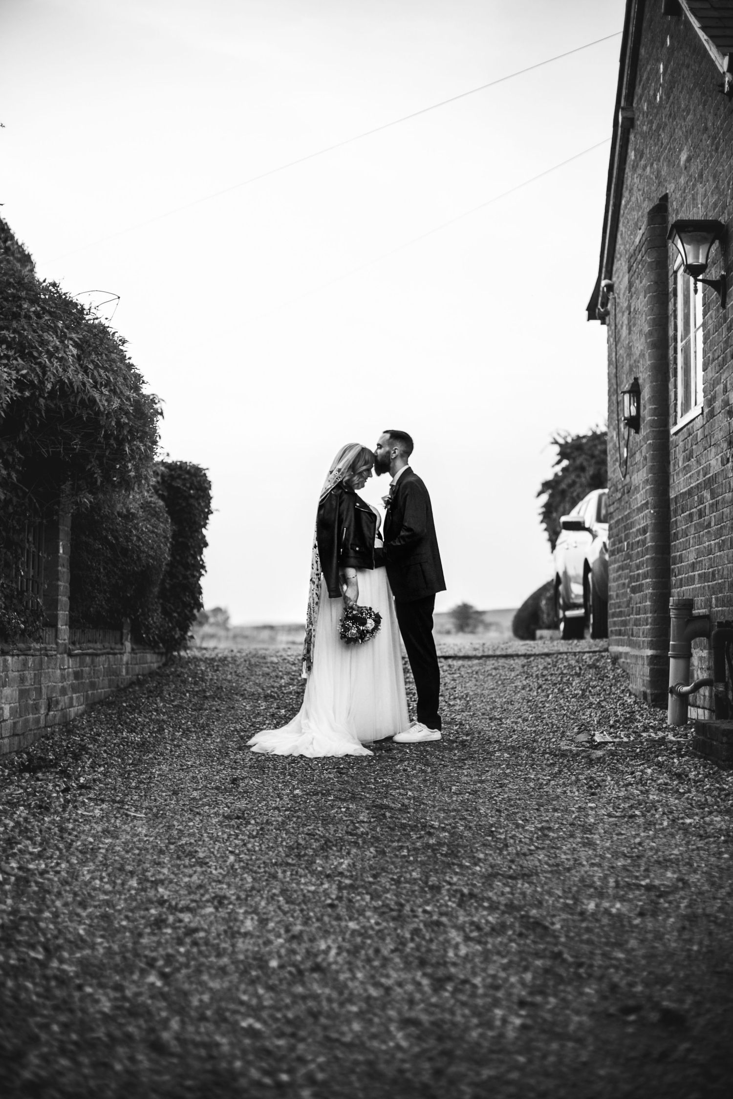 Rustic romance – The newlyweds pose in front of the historic barn