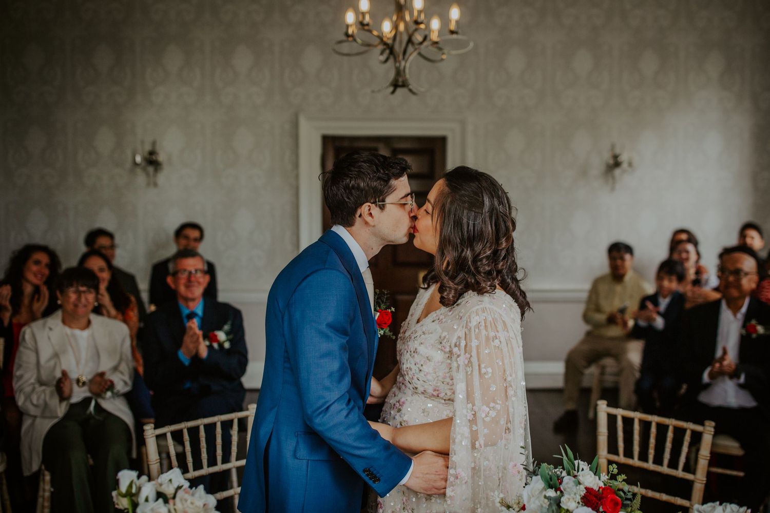 Newlyweds share their first kiss during their wedding ceremony at Morden Park.