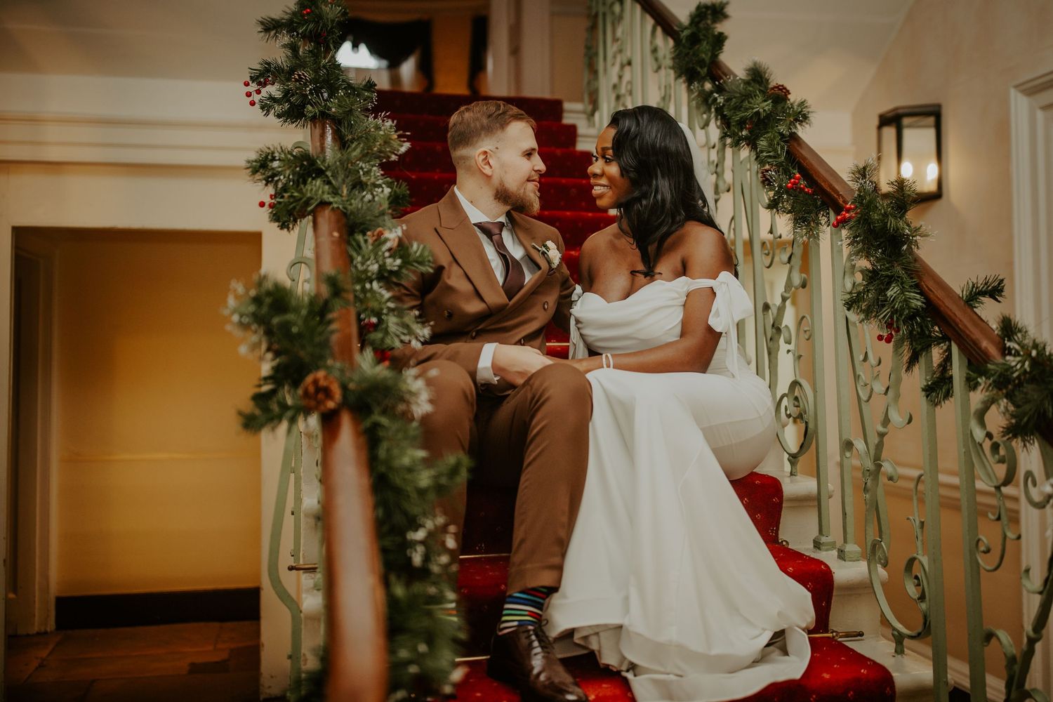 Bride and Groom sitting on the staircase after their wedding ceremony at Morden Park House - London - RELM Photography