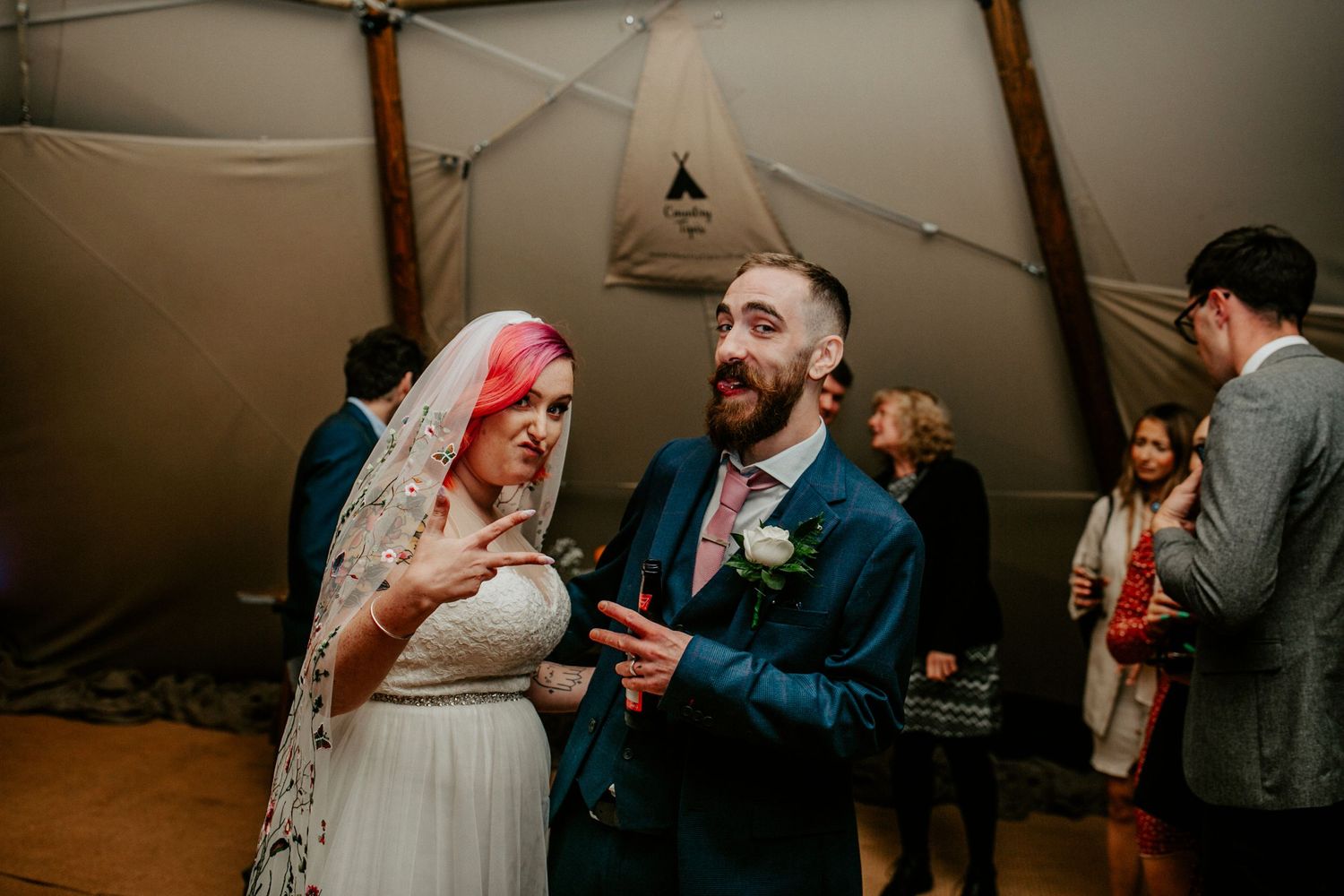 Picture perfect – The newlyweds pose for a silly photo together, the barn’s tent's lighting