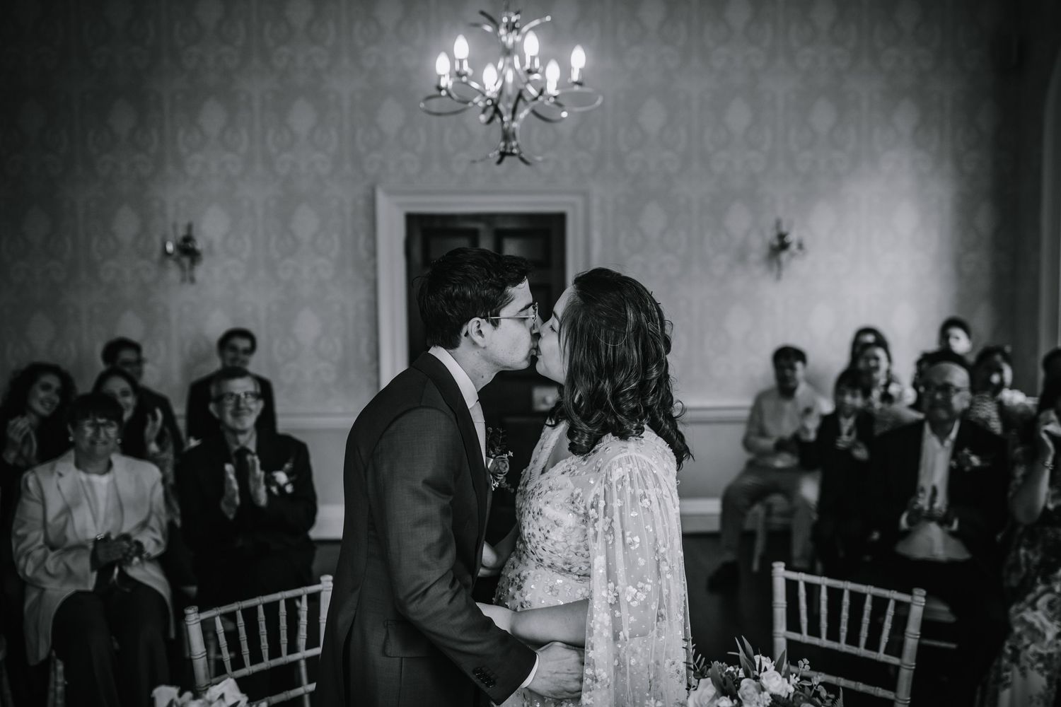 Newlyweds share their first kiss during their wedding ceremony at Morden Park.
