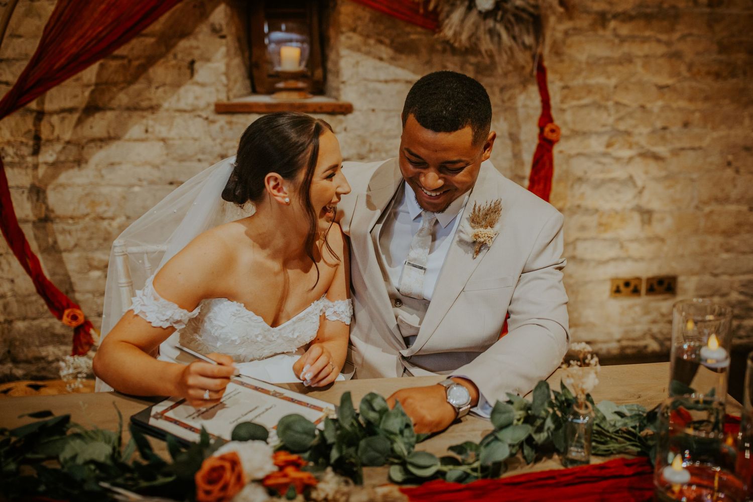 Bride and groom signing the registry at their wedding ceremony  Lapstone Barn – Chipping Campden, The Cotswolds