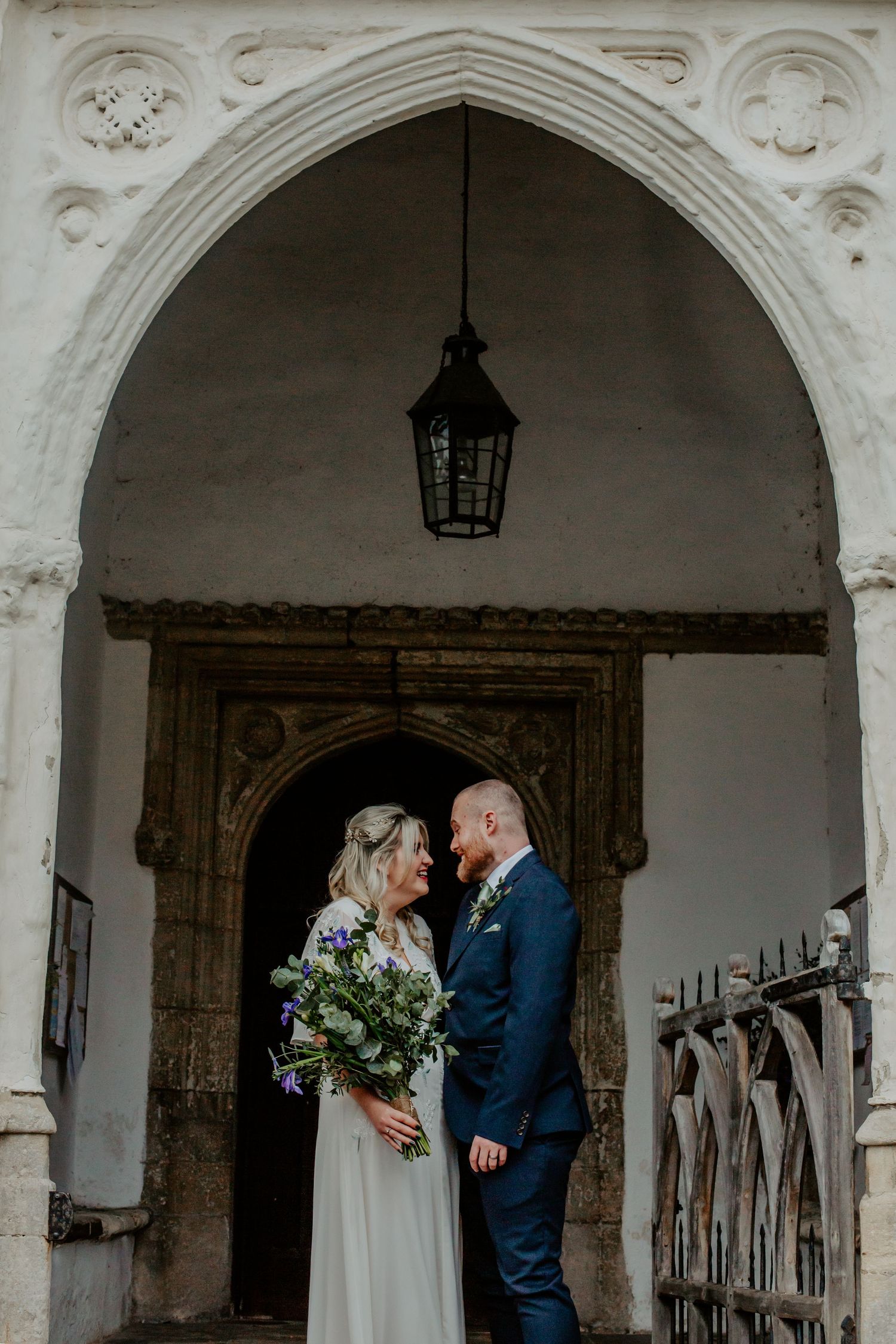 Bride and groom posing outside Braughing Church Hertfordshire, Photographer RELM Photography