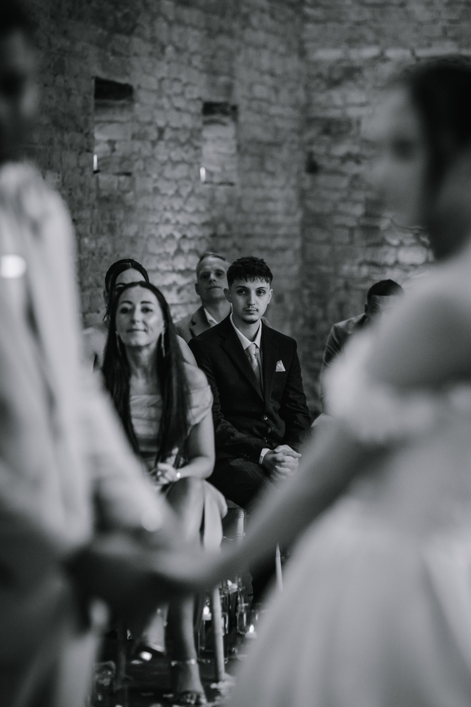 Bride and groom holding hands at their wedding ceremony - Lapstone Barn – Chipping Campden, The Cotswolds