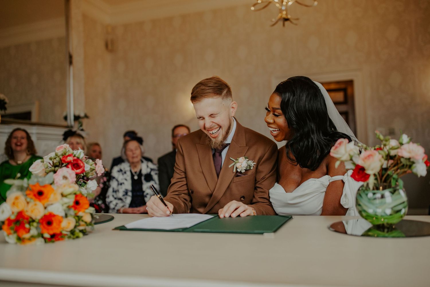 Bride and Groom signing the registry at their wedding ceremony at Morden Park House - London - RELM Photography