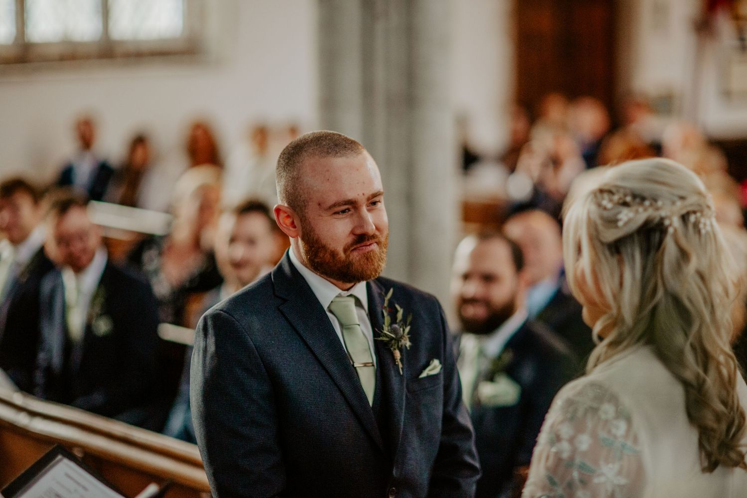 Groom looking at his bride during wedding ceremony at Braughing Church Hertfordhsire, Photographer RELM Photography