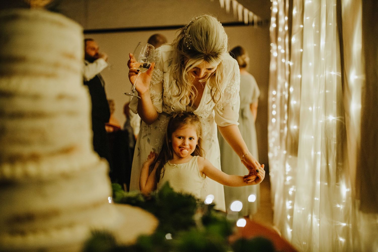 Bride and flower girl at wedding reception at Cottered Village Hall Hertfordshire, Photographer RELM Photography