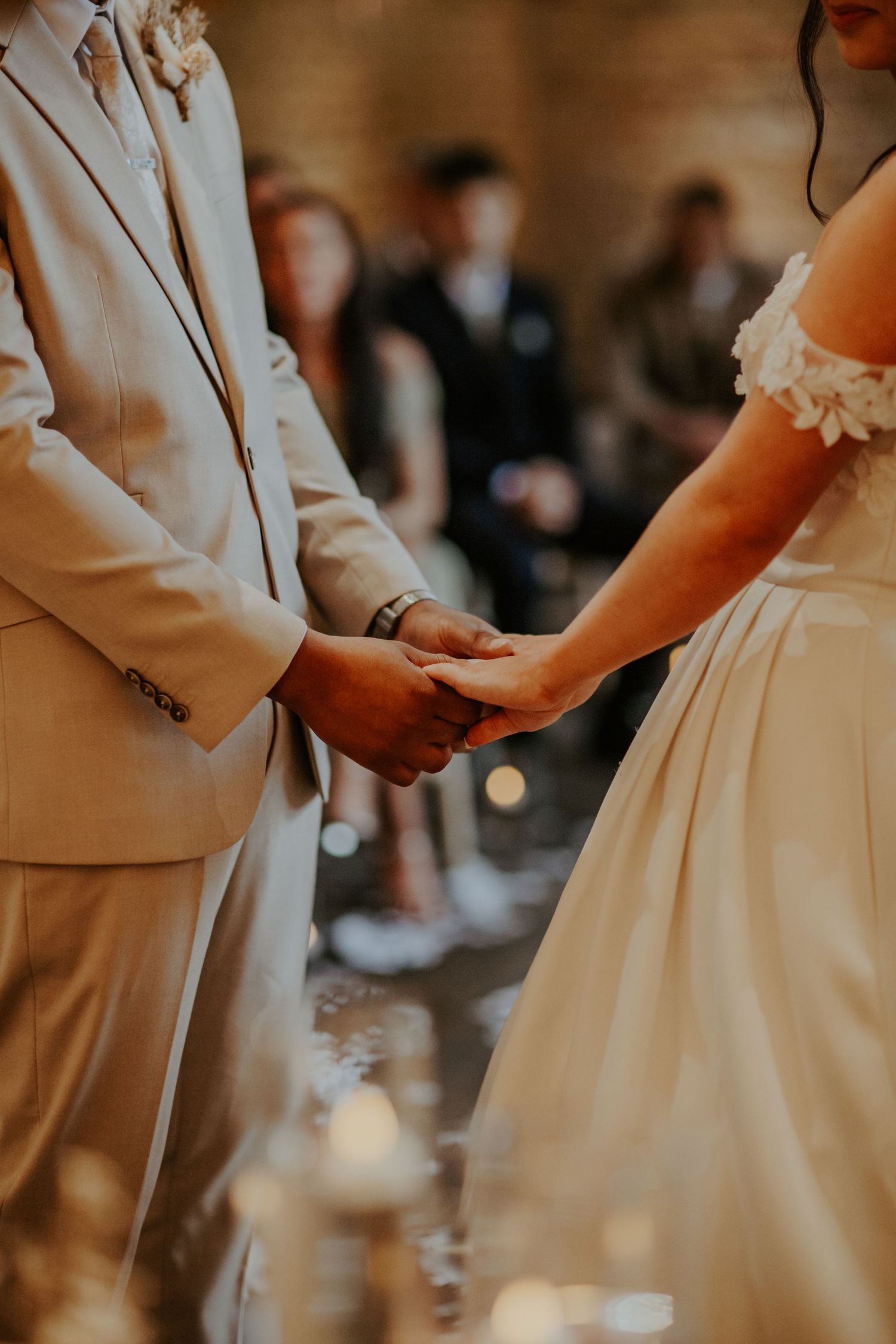 Bride and groom holding hands  at their wedding ceremony - Lapstone Barn – Chipping Campden, The Cotswolds
