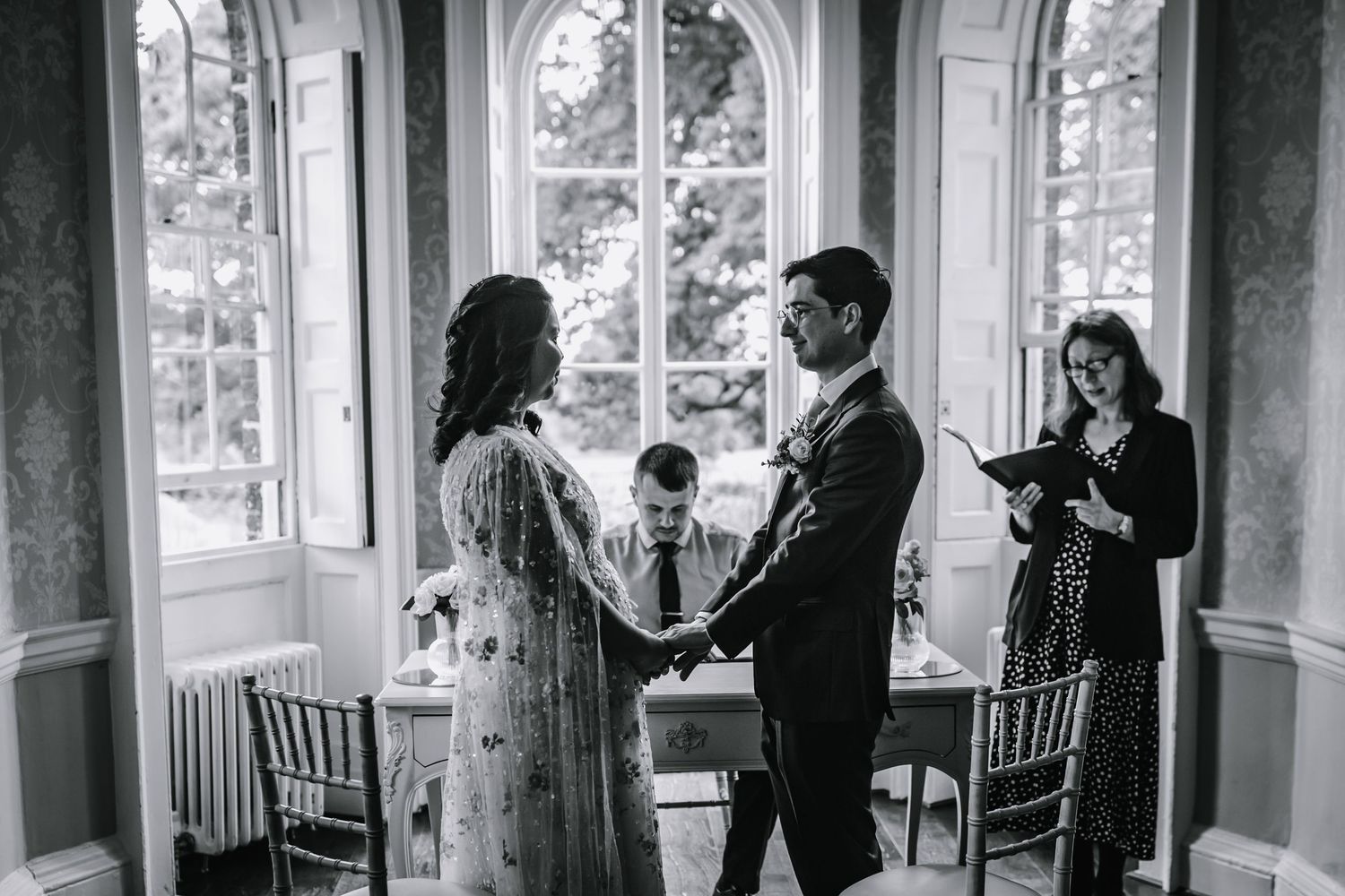 Bride and groom exchange wedding vows during an elegant ceremony at Morden Park, London.
