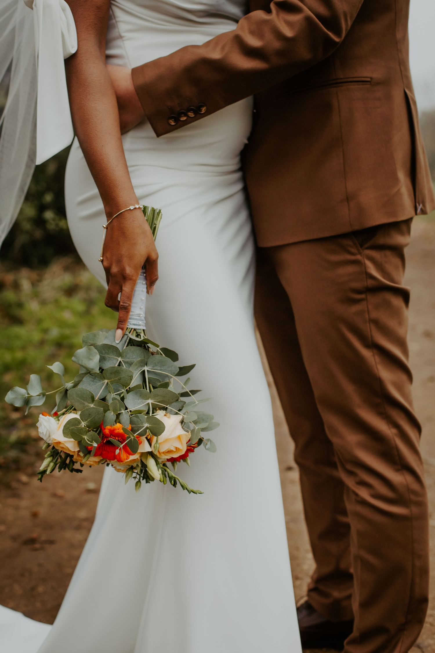 Bride being held by the groom holding Citrus Wedding Bouquet - London - RELM Photography