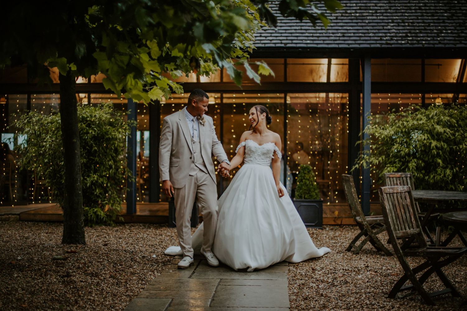 Bride and groom walking outside their wedding venue Lapstone Barn – Chipping Campden, The Cotswolds