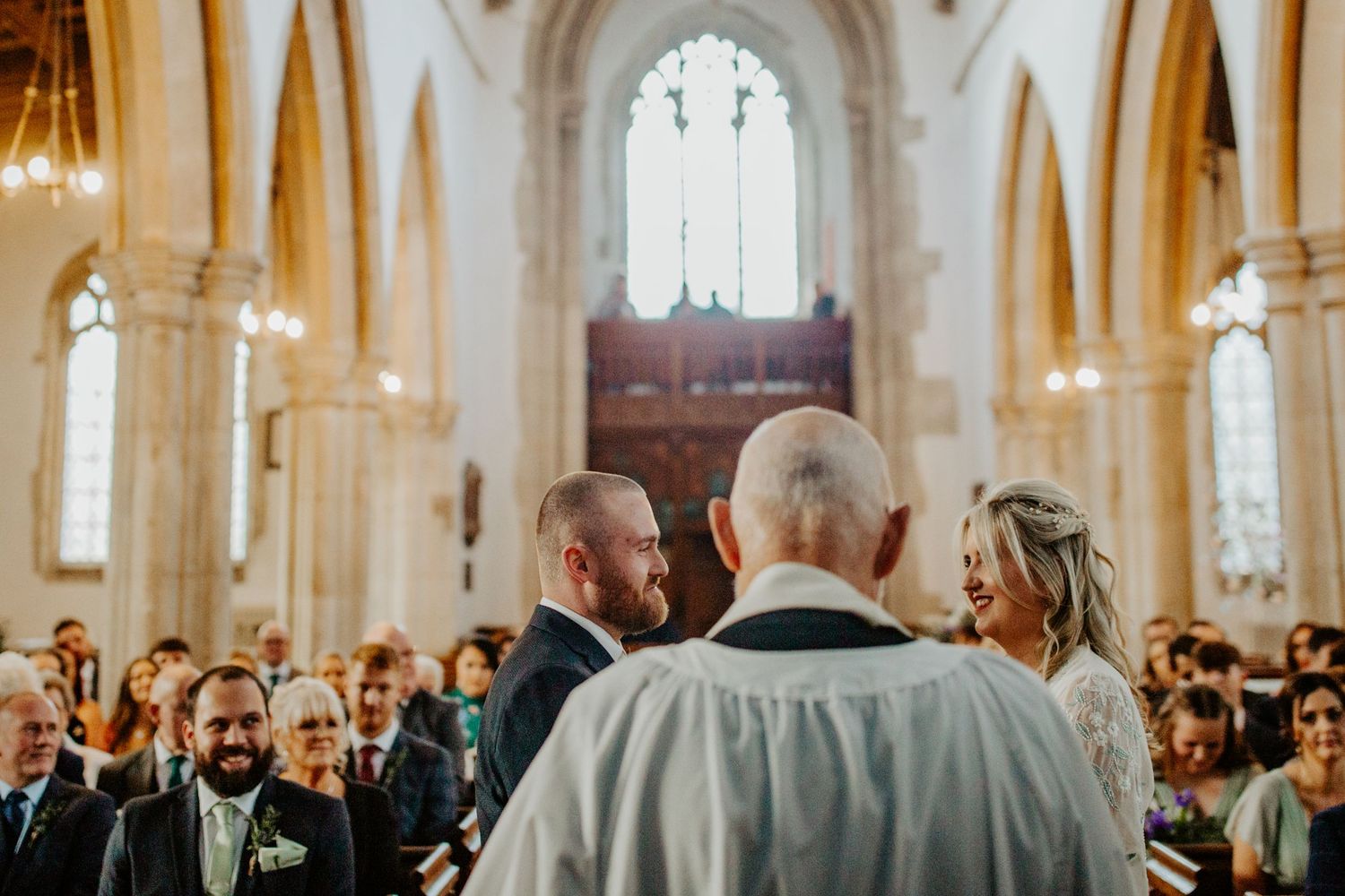 Bride and groom exchanging vows at Braughing Church, Hertfordshire – RELM Photography.
