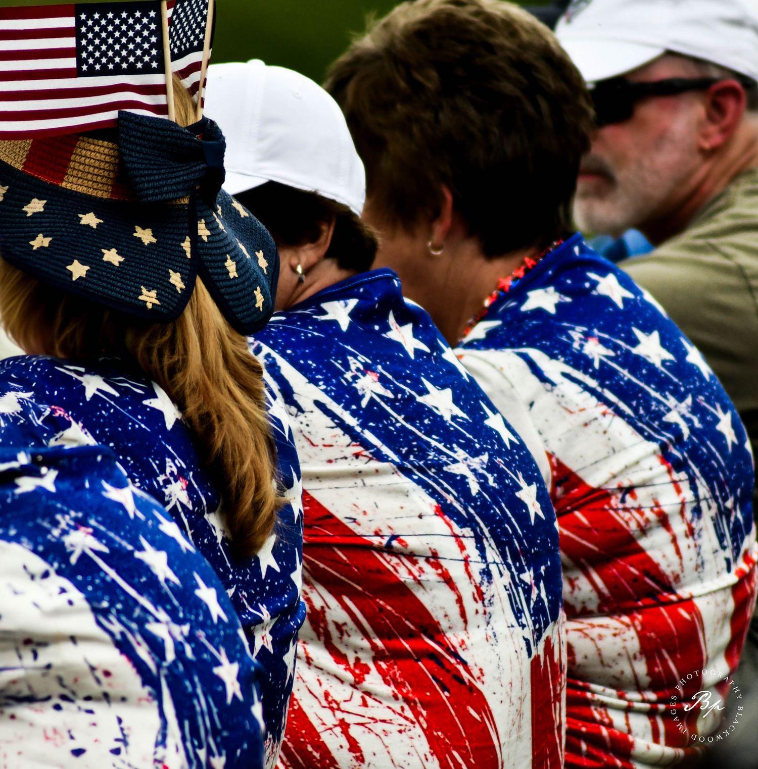 Patriotic fans wearing American flag jackets and accessories at the Solheim Cup golf tournament.