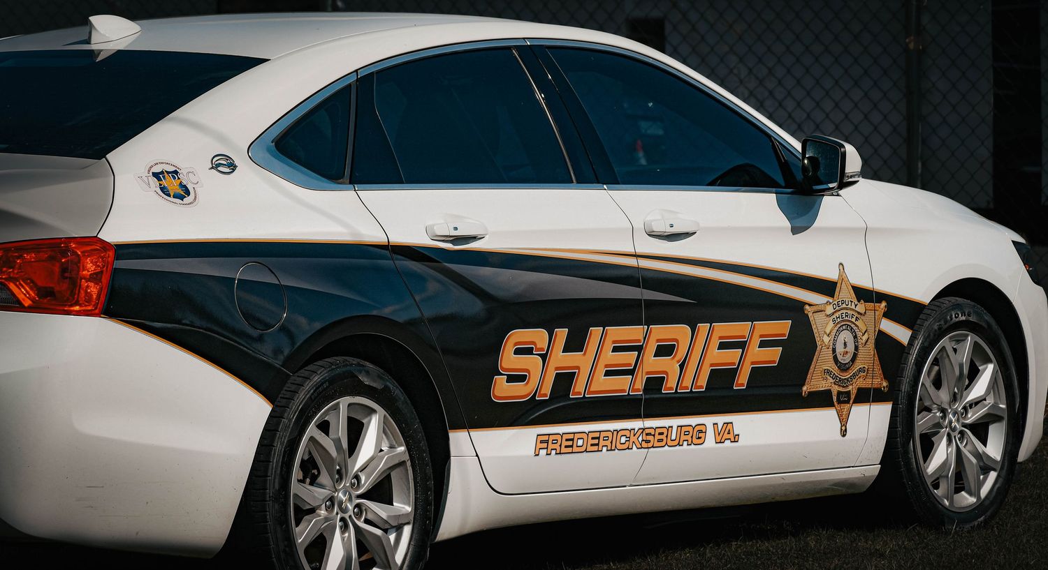 Fredericksburg Virginia Sheriff department patrol car with gold badge logo on door.