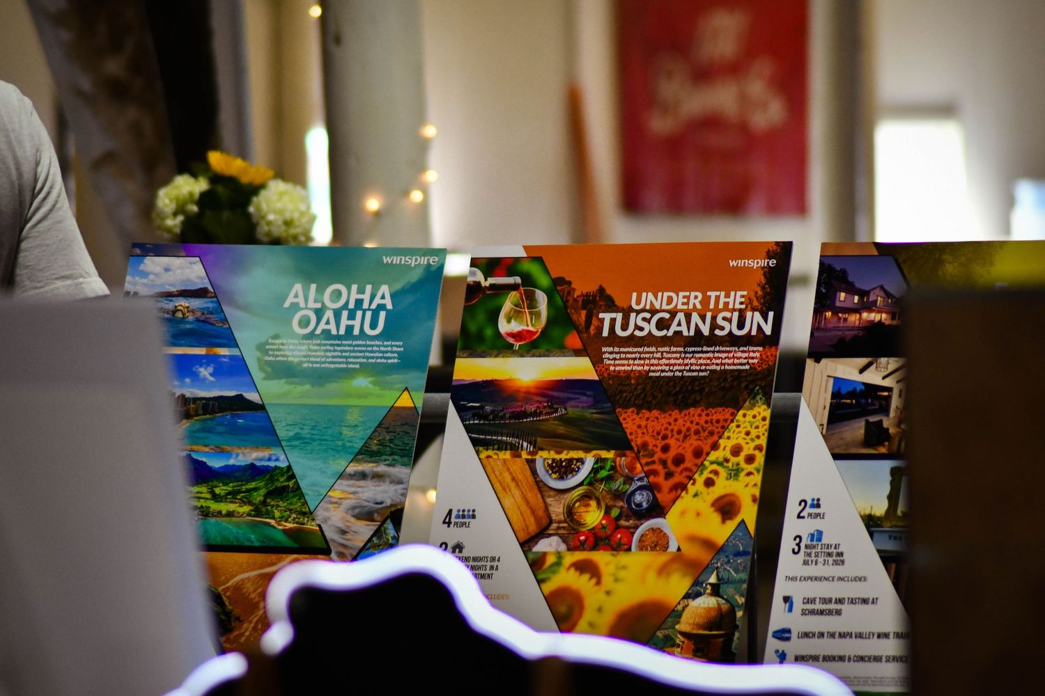 Travel brochures for Aloha Oahu and Under the Tuscan Sun displayed on a table.