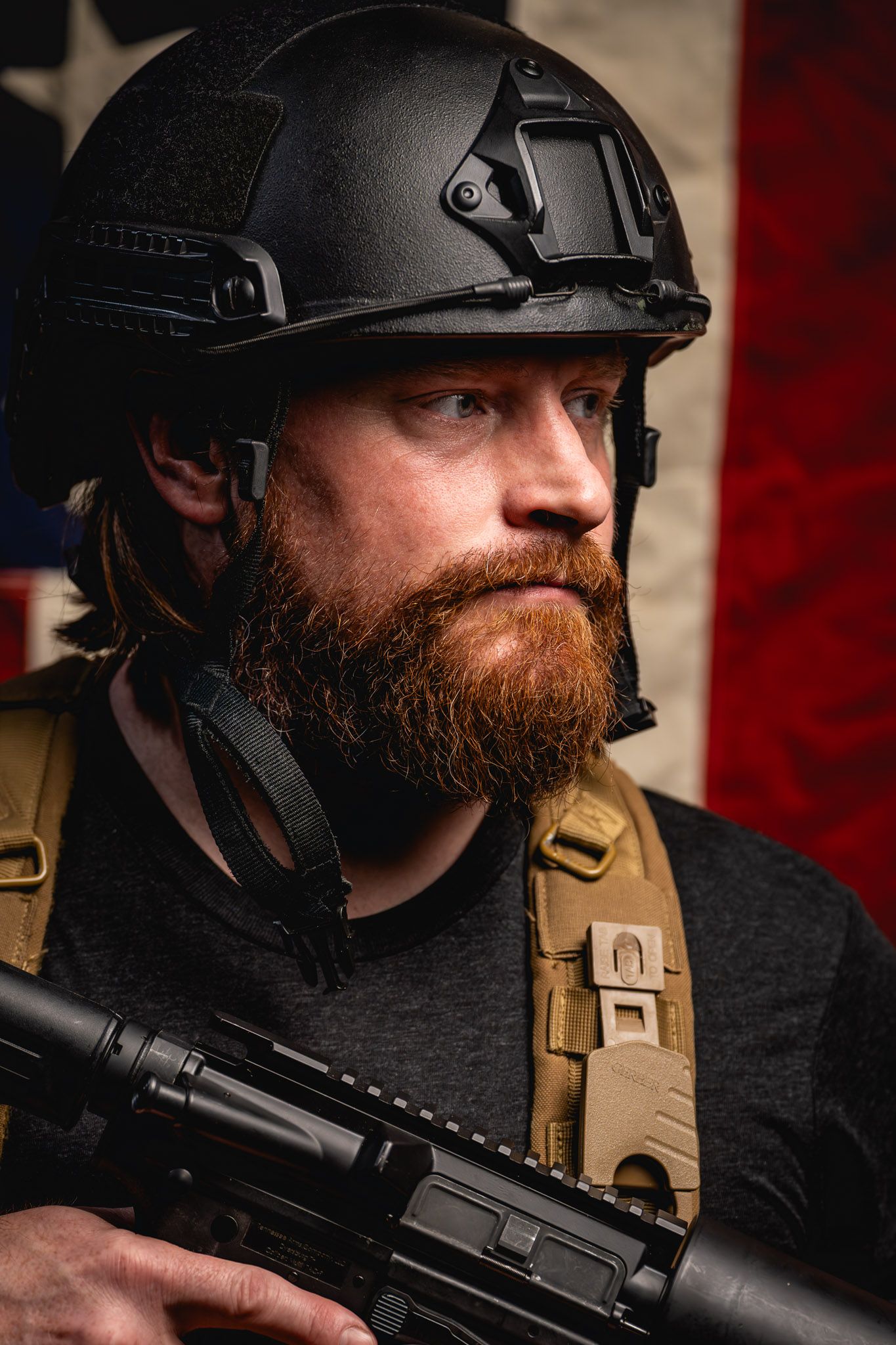 Tactical veteran posing with Can Cannon and smiling proudly against a rugged American flag backdrop.