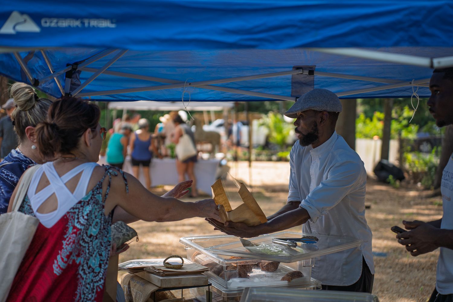 Visitors explore artisan vendor tents during the Bluffton Farm and Flea grand opening in Bluffton, South Carolina.