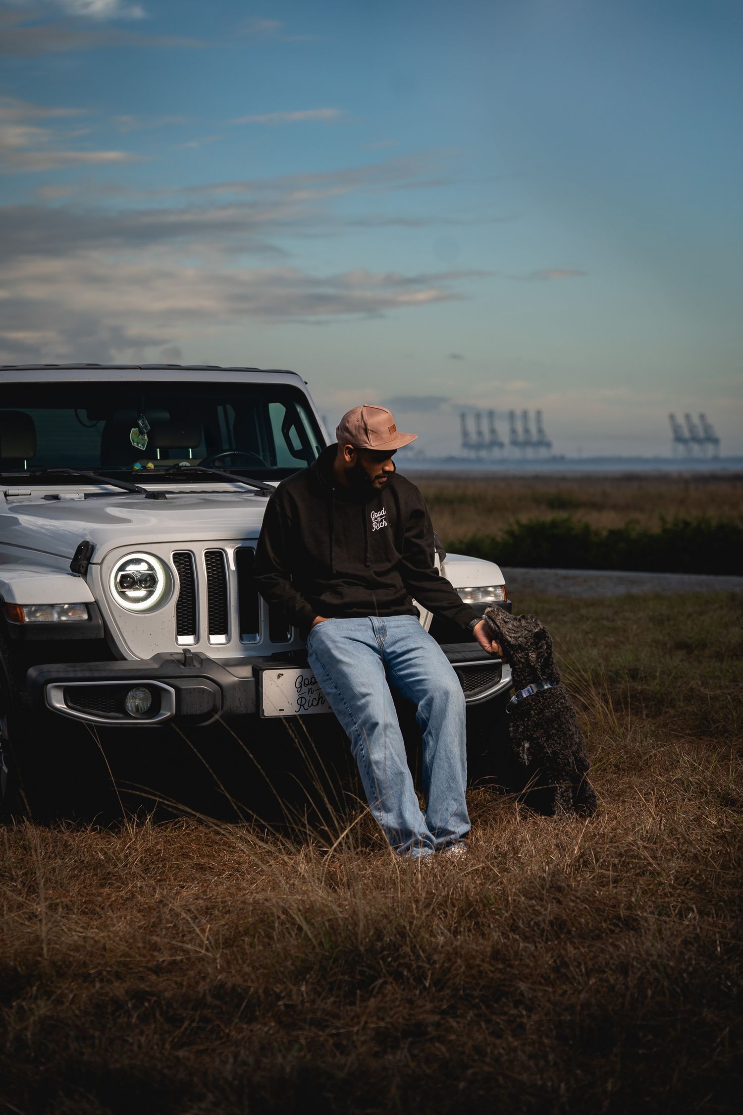Lifestyle portrait photography in the South Carolina Lowcountry featuring a man and dog beside a Jeep by GoodnRich Photography