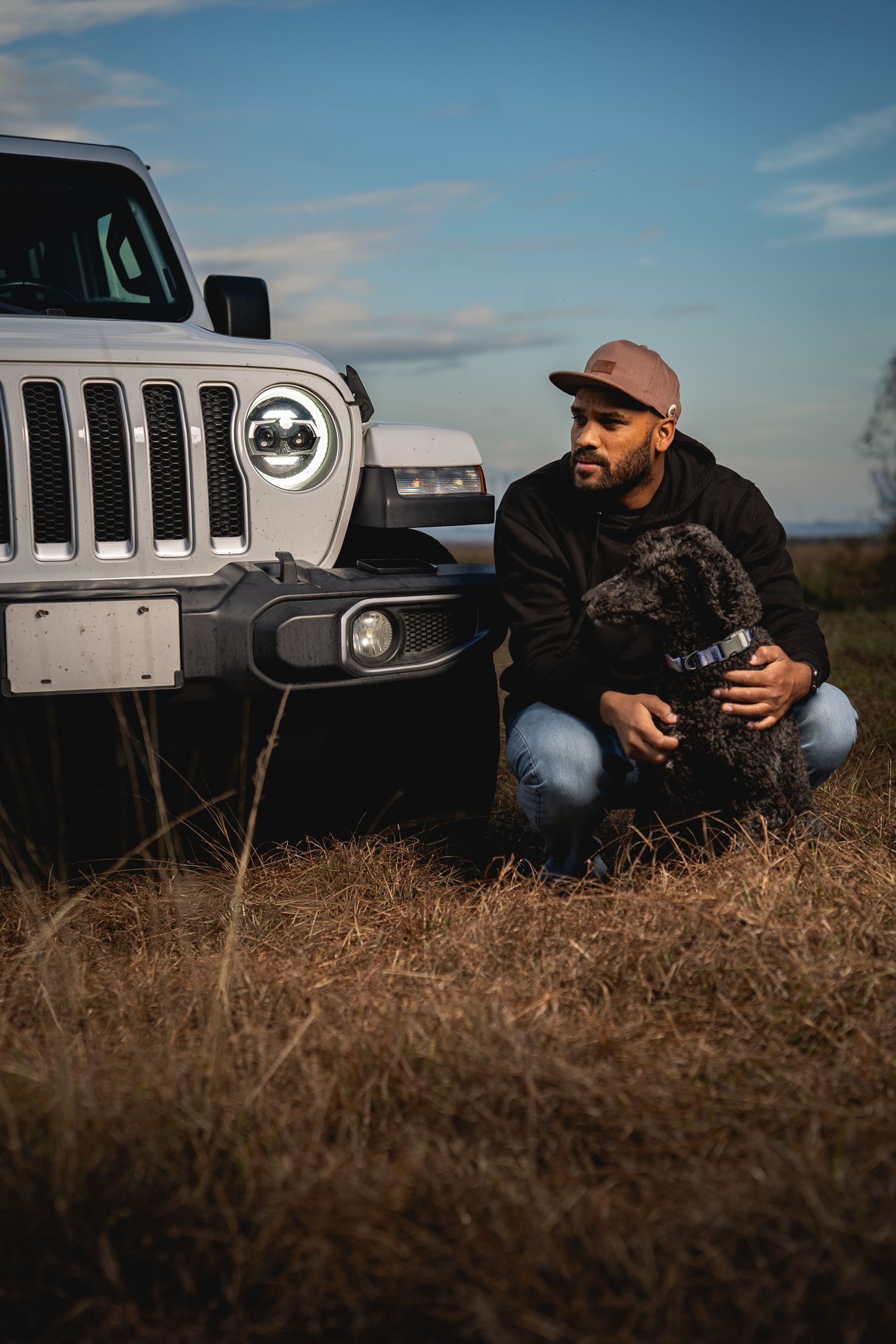 Lifestyle portrait photography in the South Carolina Lowcountry featuring a man and his dog beside a Jeep by GoodnRich Photography
