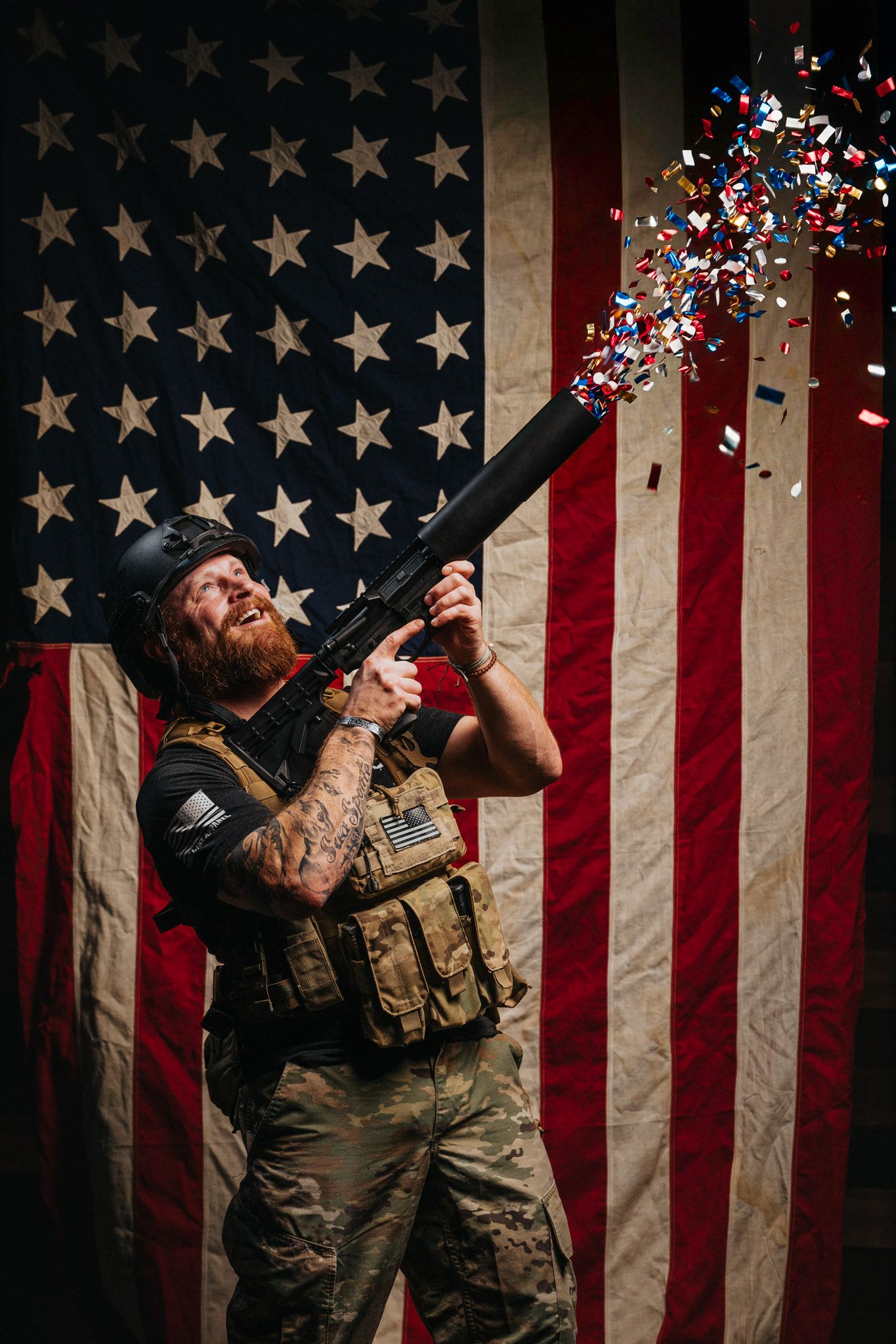 Veteran holding a Can Cannon in front of an American flag, posing for a New Year’s themed Nine Line Apparel photoshoot.