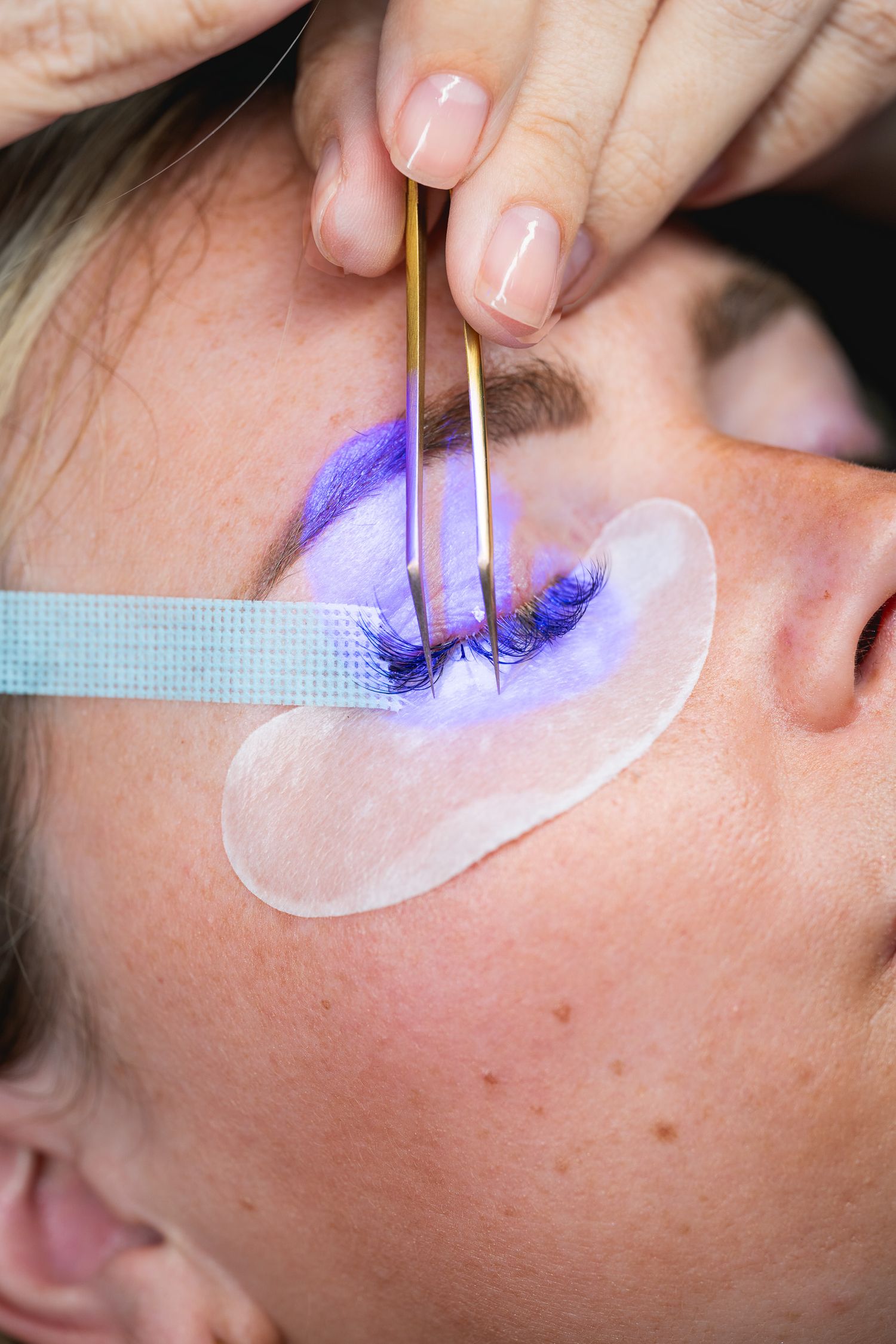 Close-up of precision tweezers and lash tools being used during an
eyelash extension application at Flirt Lash Loft in Bluffton, South
Carol