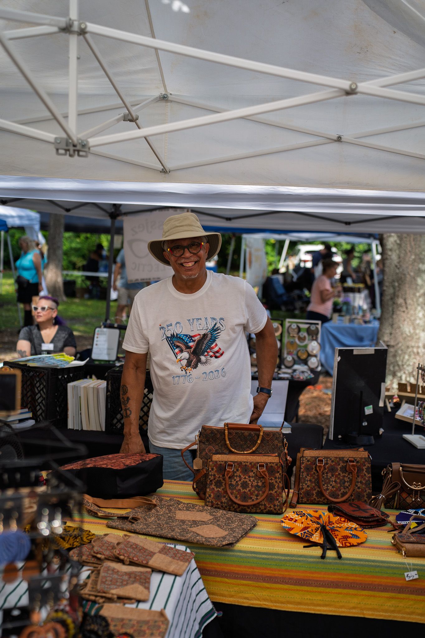 A local artisan smiles while welcoming shoppers at the Bluffton Farm and Flea grand opening in Bluffton, South Carolina.