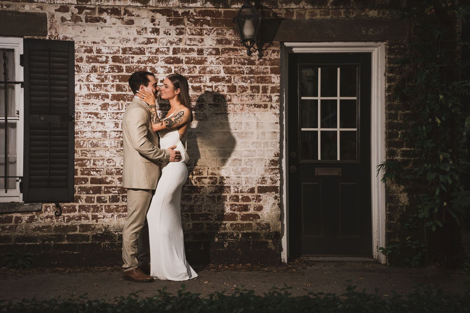 Romantic couples photography session in Savannah featuring cinematic lighting and historic brick architecture by GoodnRich Photography
