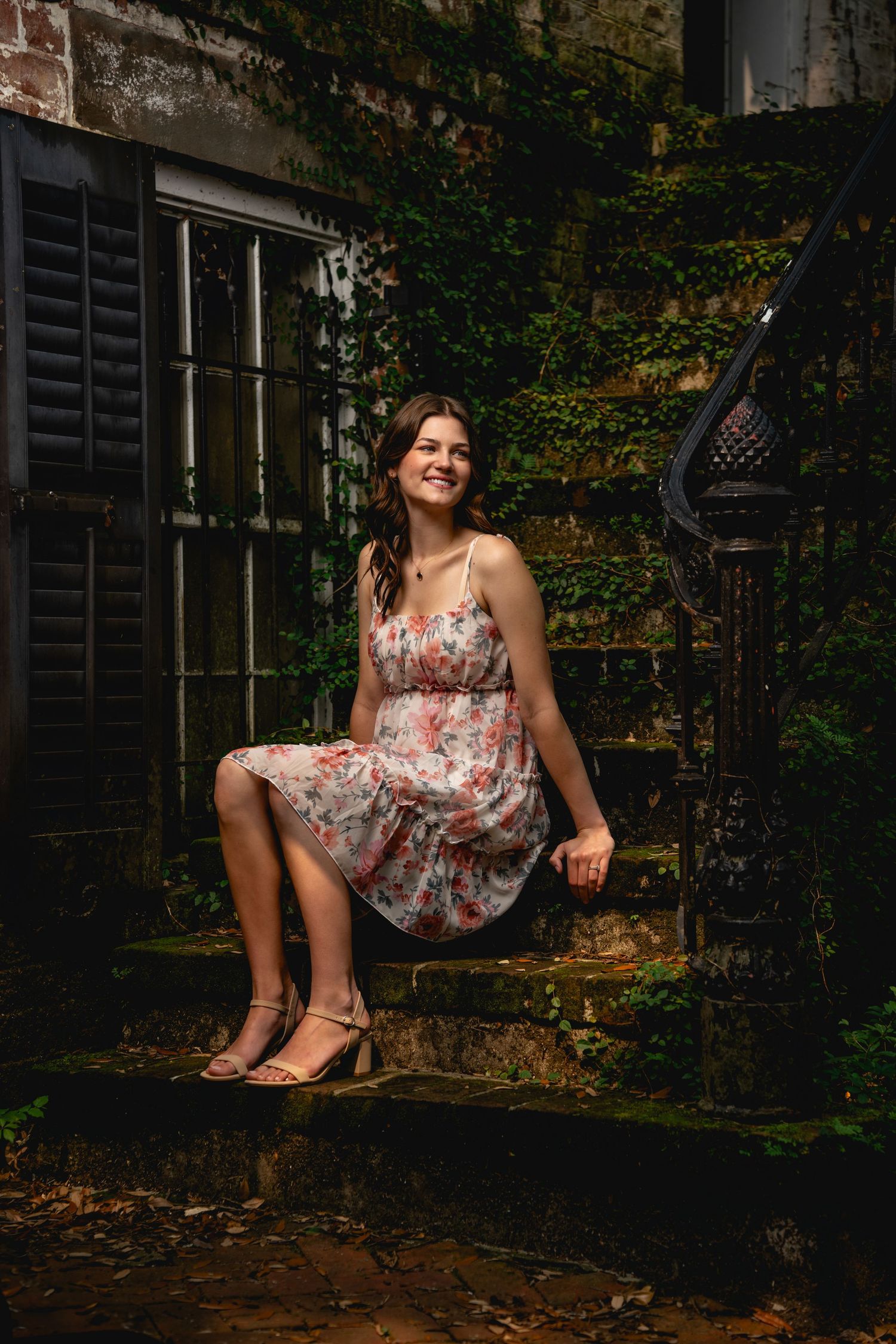 Graduation portrait photography in Savannah featuring historic brick architecture and cinematic natural light by GoodnRich Photography