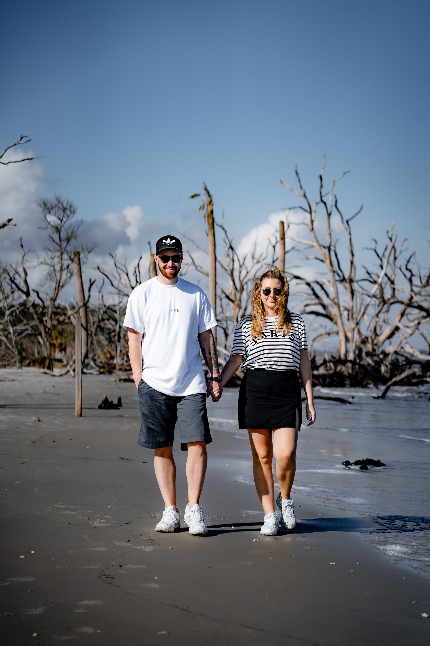 Couples lifestyle photography session on Hilton Head Island beach featuring a couple walking together along the shoreline captured