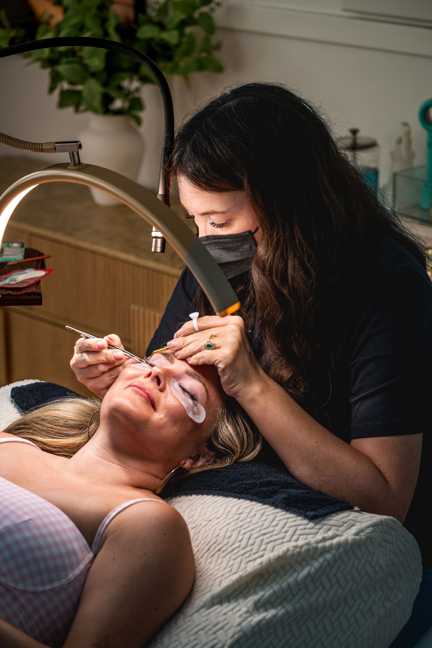 Lash artist at Flirt Lash Loft in Bluffton, SC applying eyelash
extensions to a client during a professional lash appointment.