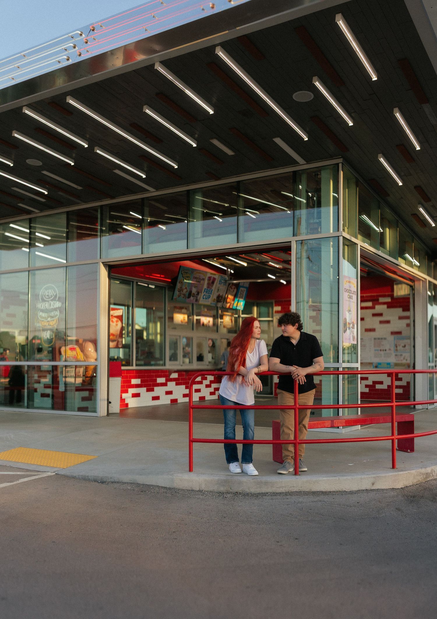 Couple with red-haired girl and dark-haired boy standing outside a modern fast food restaurant at dusk. Tulsa Photographer