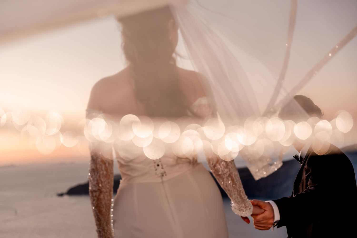 Bride and groom walking hand in hand after their wedding ceremony in Santorini at sunset 🌅,