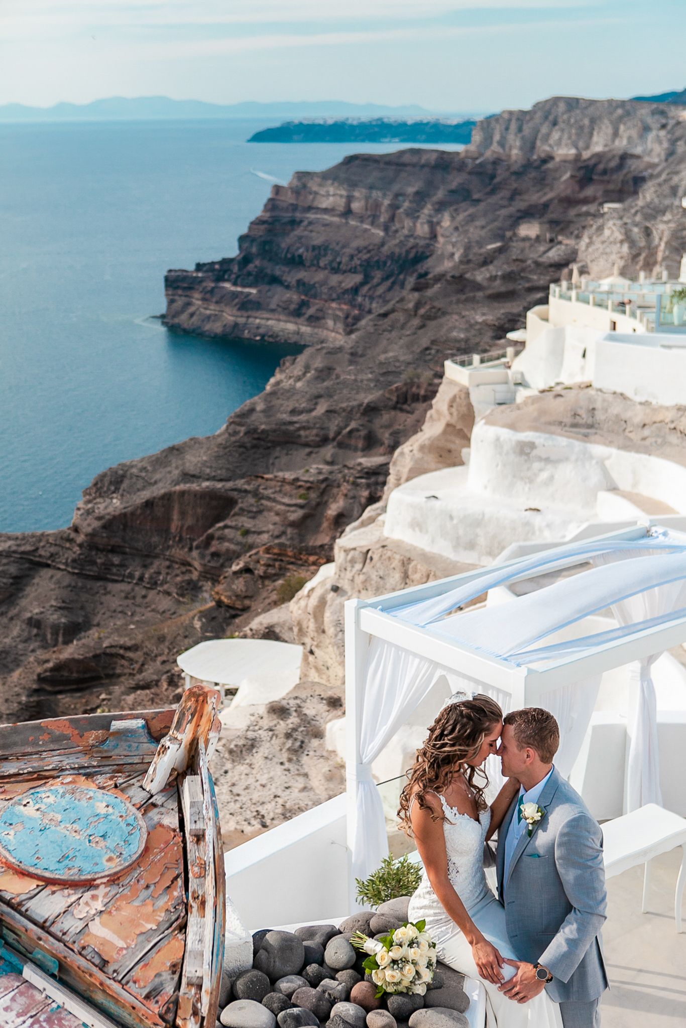 Newlyweds embracing in Santorini, natural light highlighting joy and intimacy
