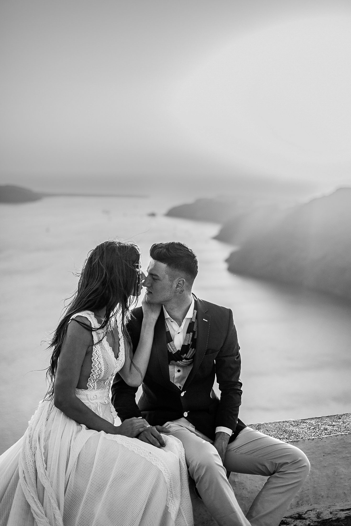 Bride and groom sharing a kiss during a sunset Santorini elopement 🌅