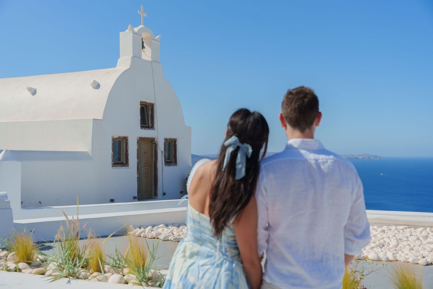 Romantic couple enjoying a morning lifestyle session in Santorini, candid and natural
