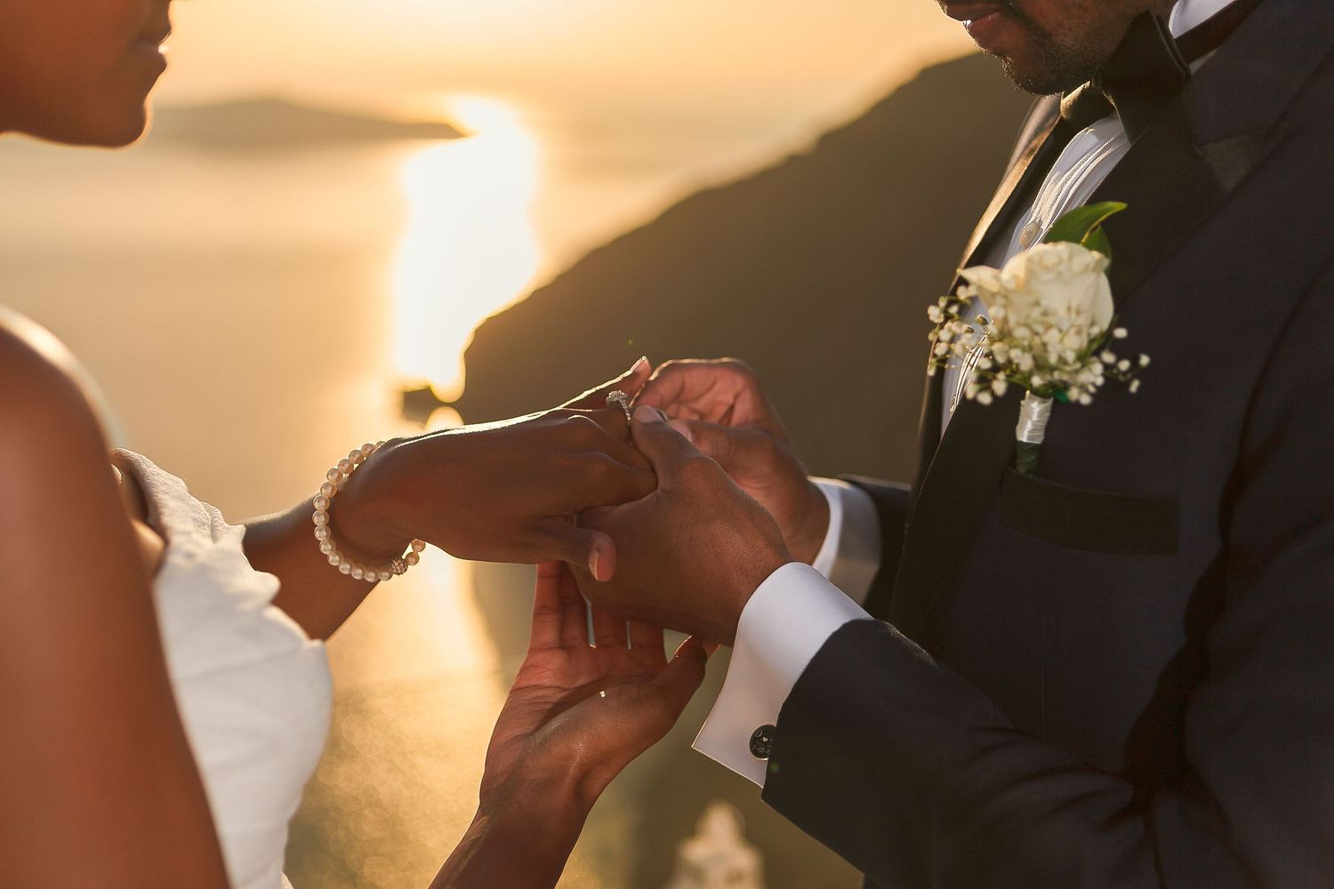 Bride and groom saying yes during a Santorini sunset elopement, surrounded by light and flowers 🌅