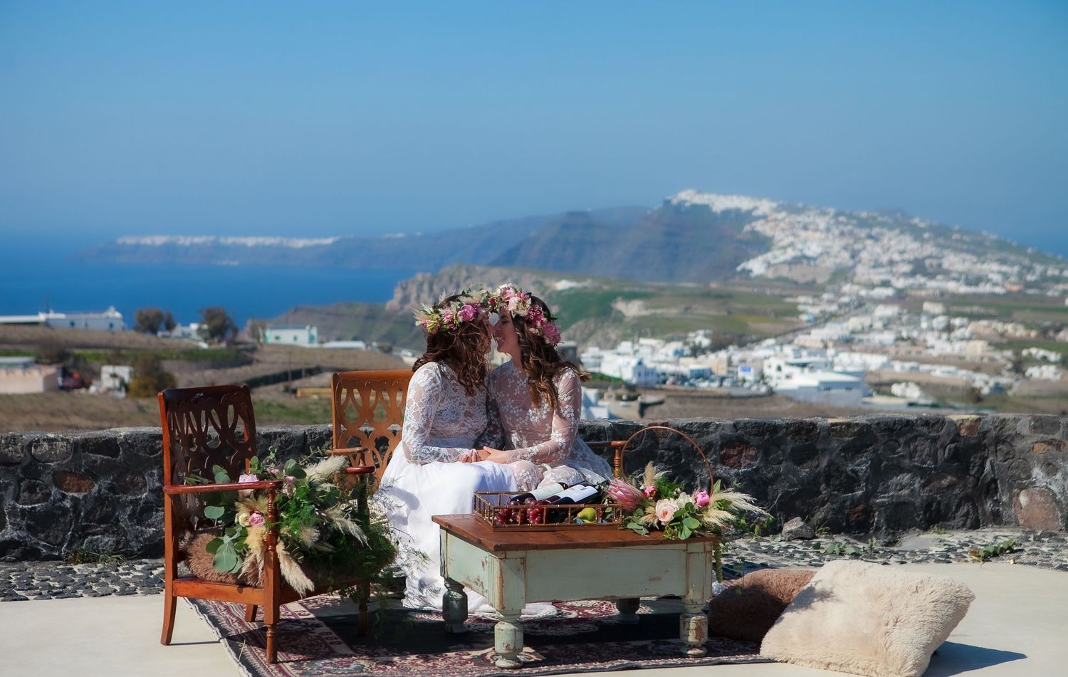 Romantic same sex elopement photoshoot in Santorini, capturing fun moments, authentic connection, and scenery