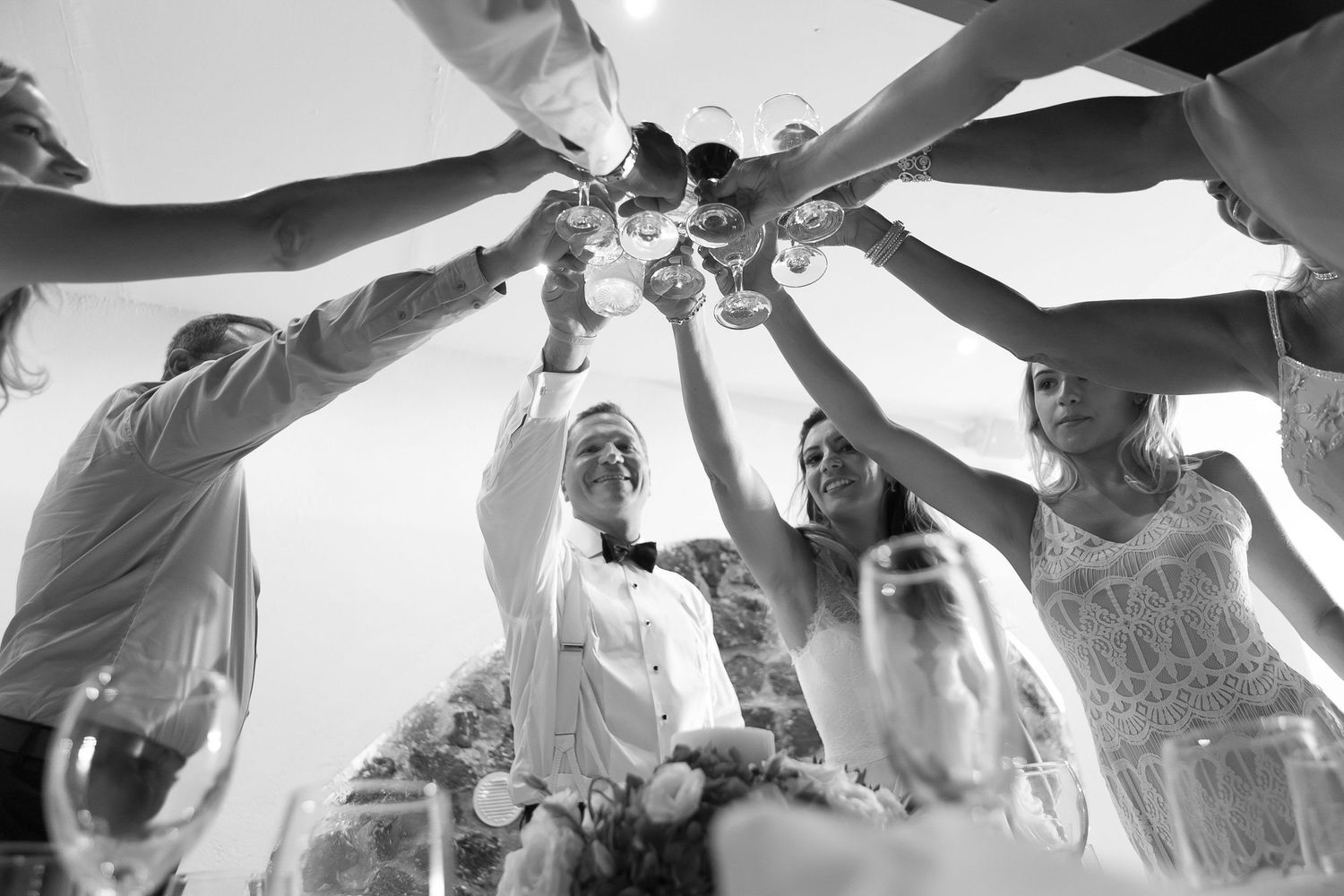 Cheerful wedding moment captured on a Santorini venue during the reception, celebrating love and togetherness