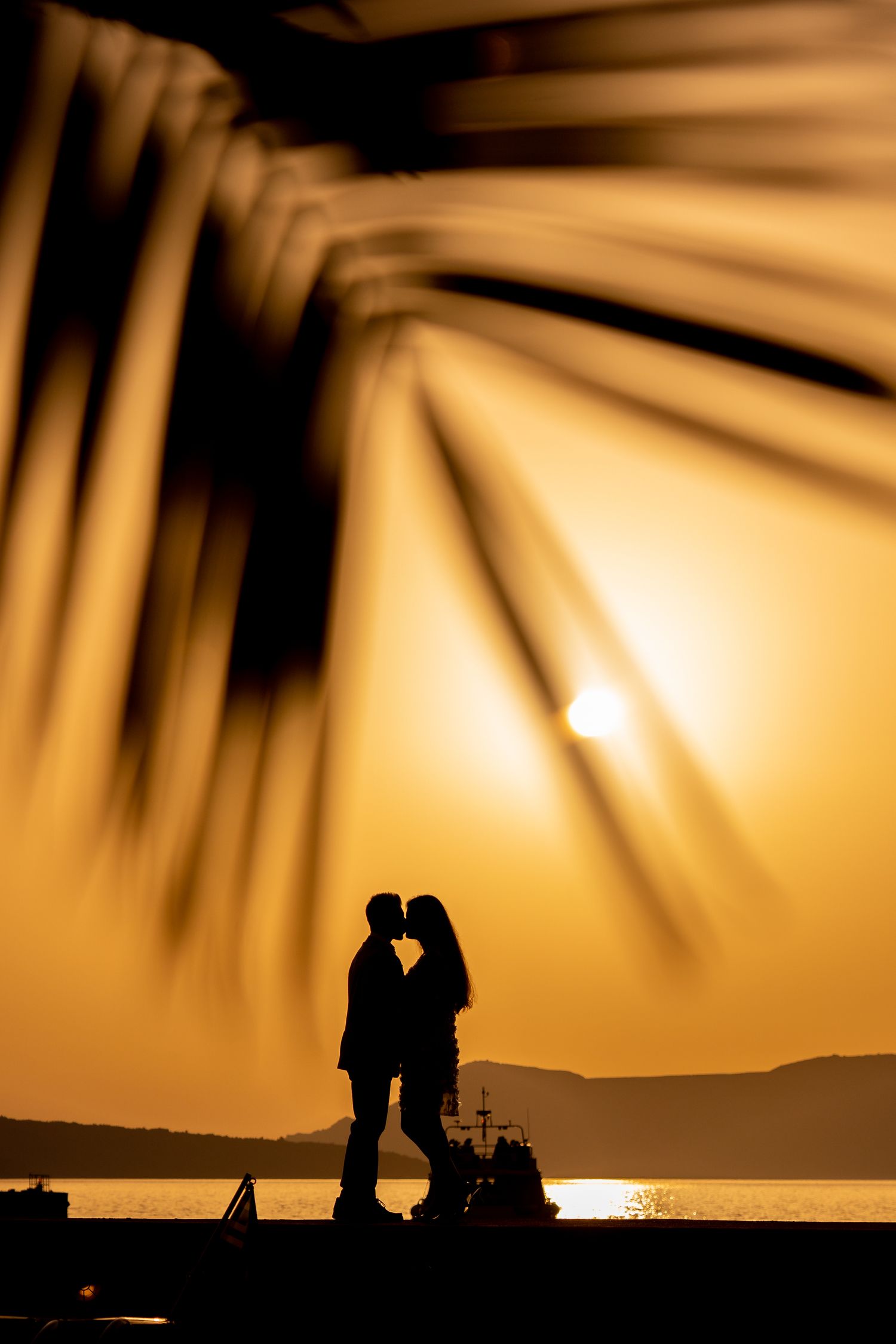 Bride and groom sharing a kiss during a sunset Santorini elopement 🌅