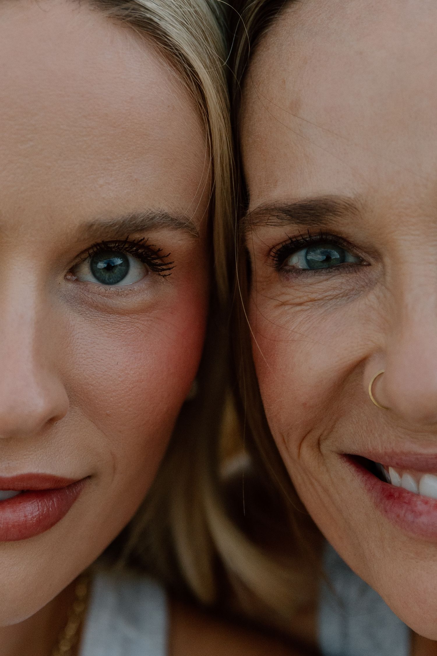 Close-up portrait of two blonde women with blue eyes and similar features side by side.
