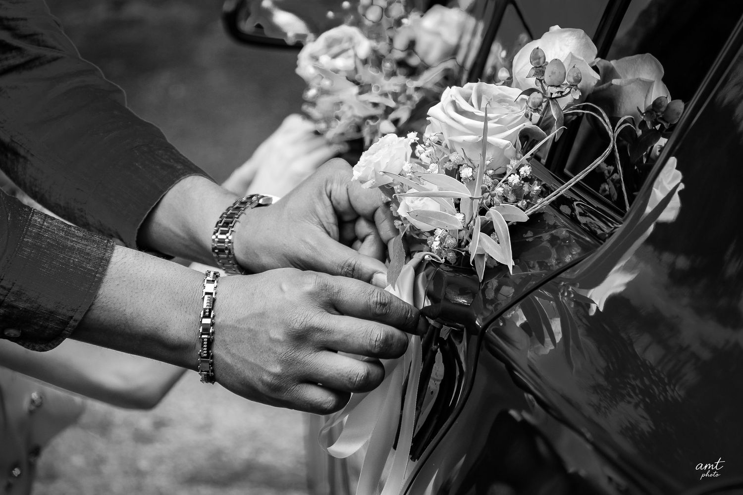 Close-up details of hands holding delicate floral arrangements in monochrome.