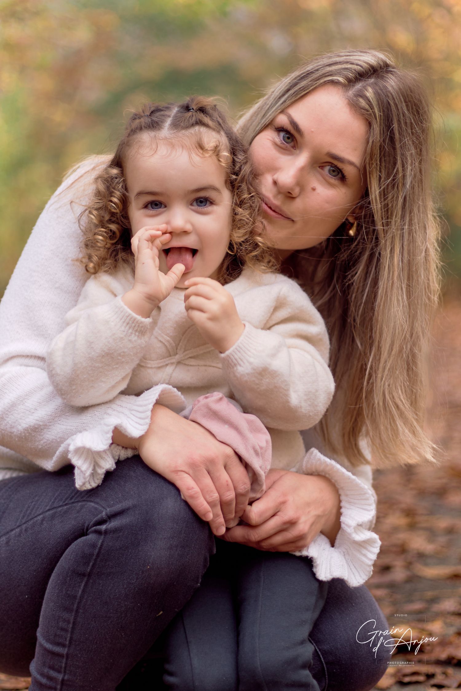 Sweet autumn photoshoot showing playful moments in cozy cream sweaters.