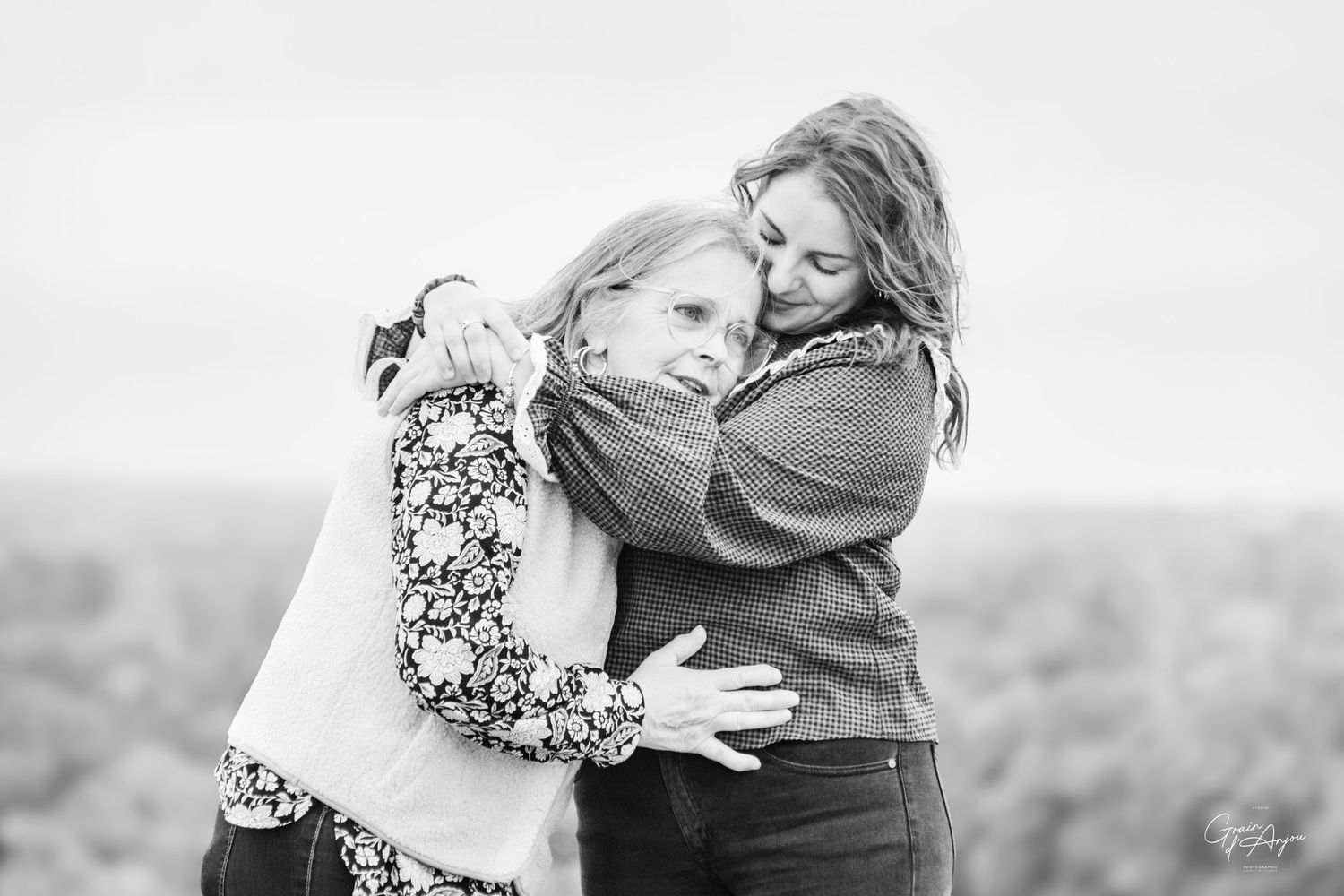 A romantic black and white photo series capturing tender embraces between a couple.