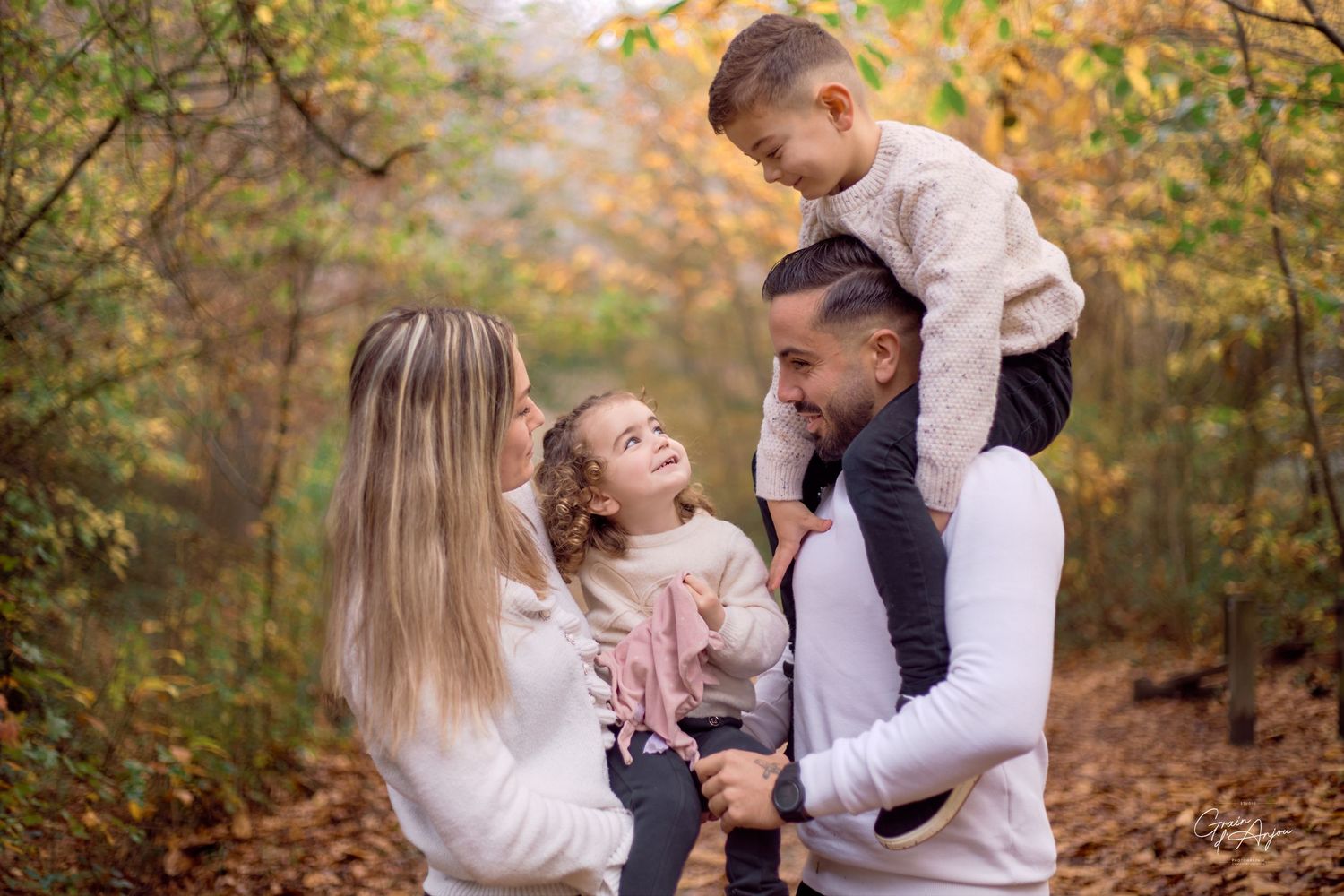 Candid family photo session in a fall setting with warm autumn colors.