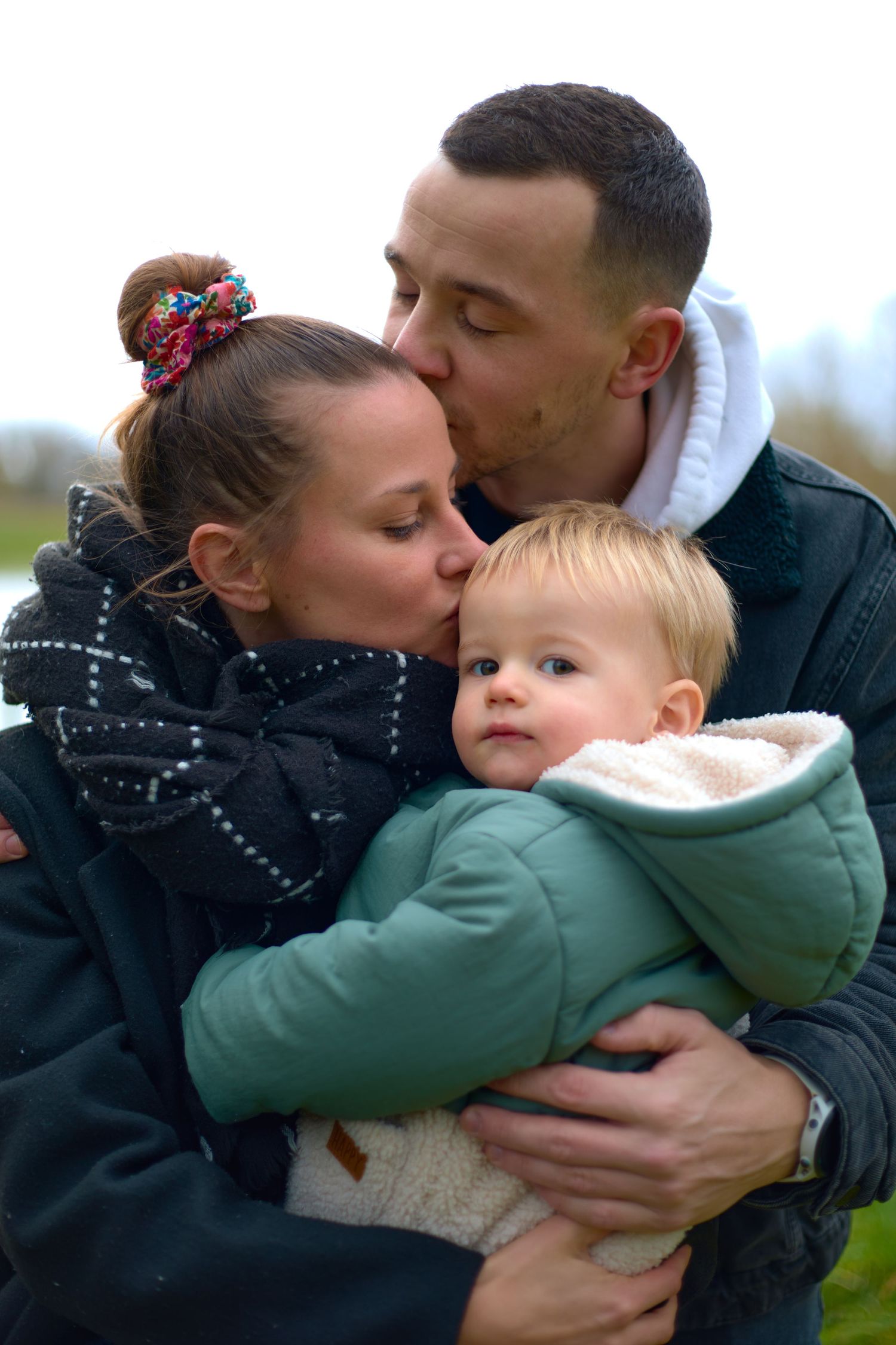 Tender family embrace captured in a series of intimate outdoor moments.