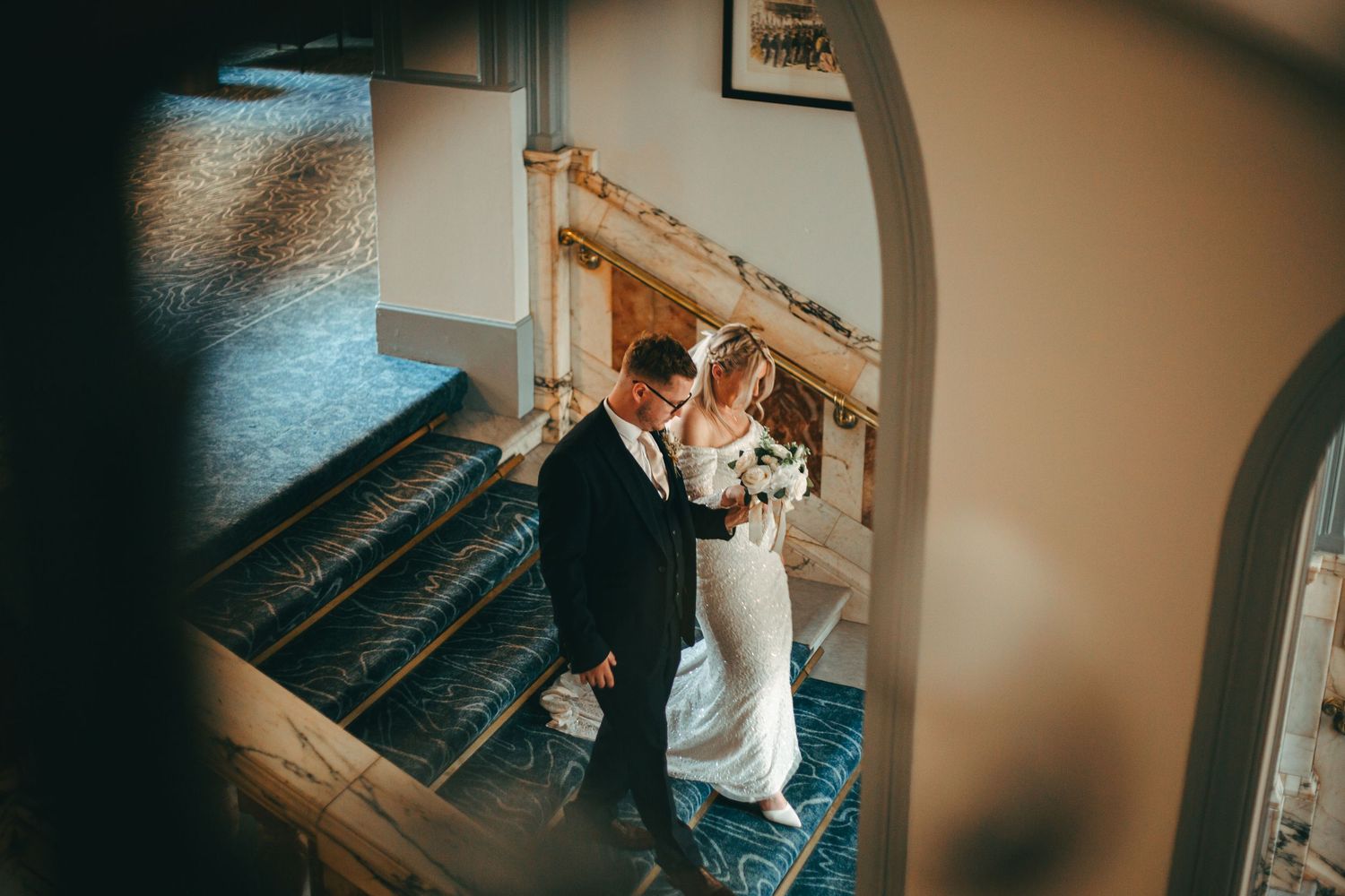 A wedding couple in the metropole hotel in Brighton for some portraits on the grand staircase