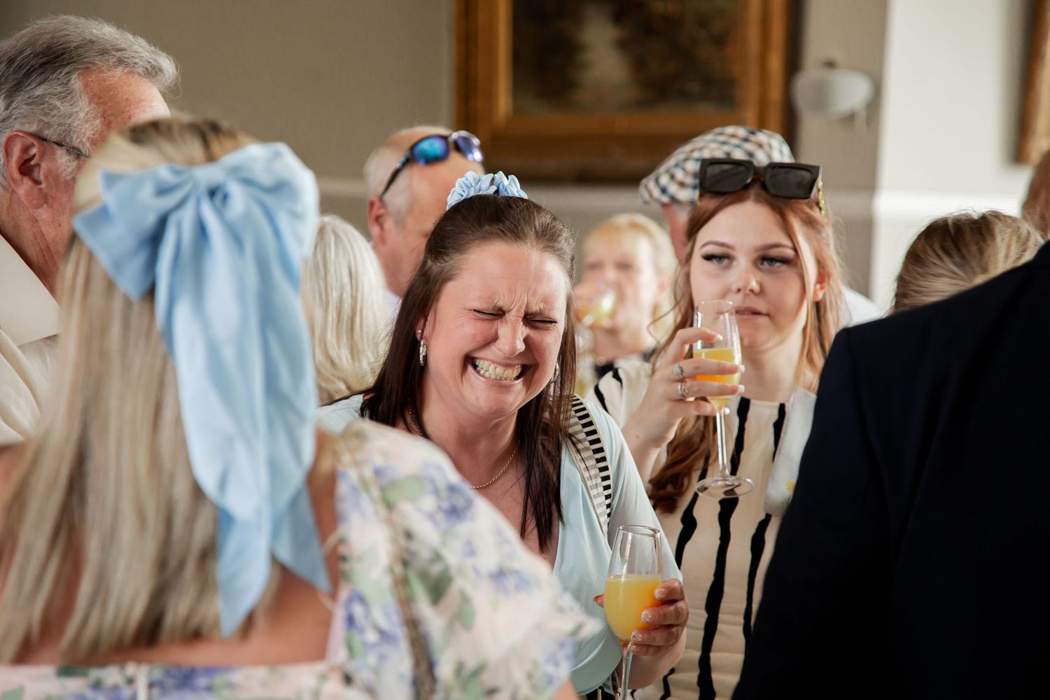 Wedding guests share joyful laughter during a reception celebration at Arundel Town Hall