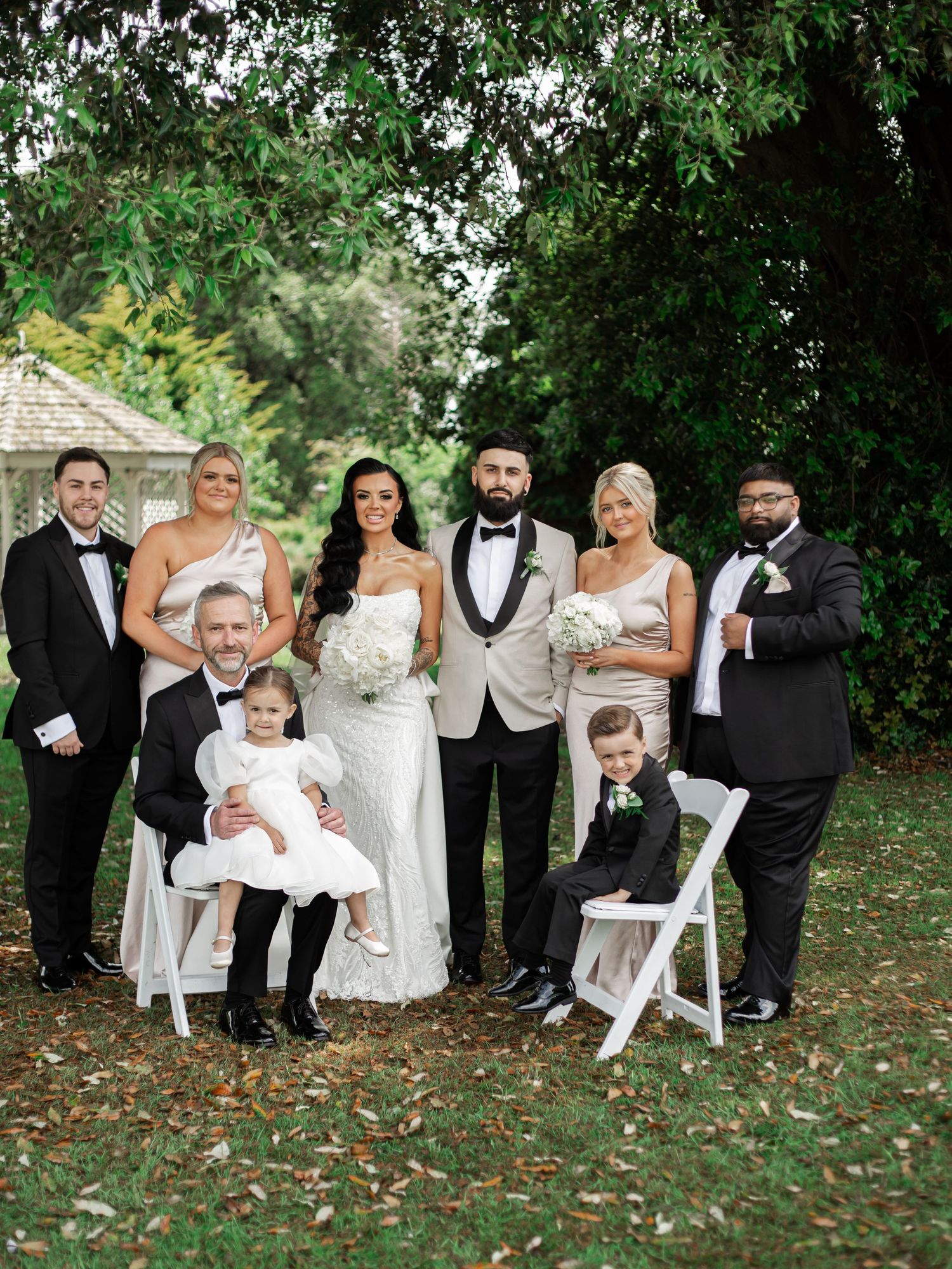 A formal wedding party portrait in the grounds of Avisford Park Hotel.